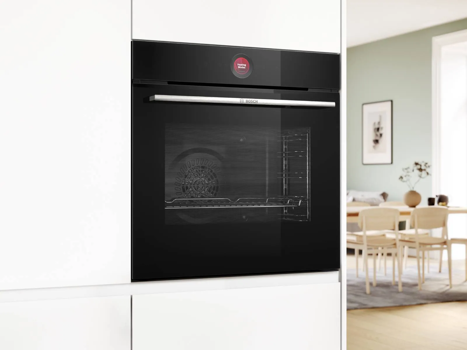 Bosch ovens built into white cabinets in light style kitchen.