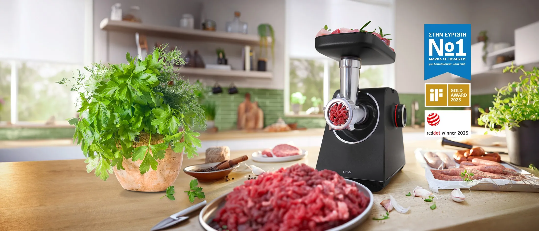 A sleek black meat grinder sits on a kitchen counter, with fresh minced meat nearby and award labels featured.