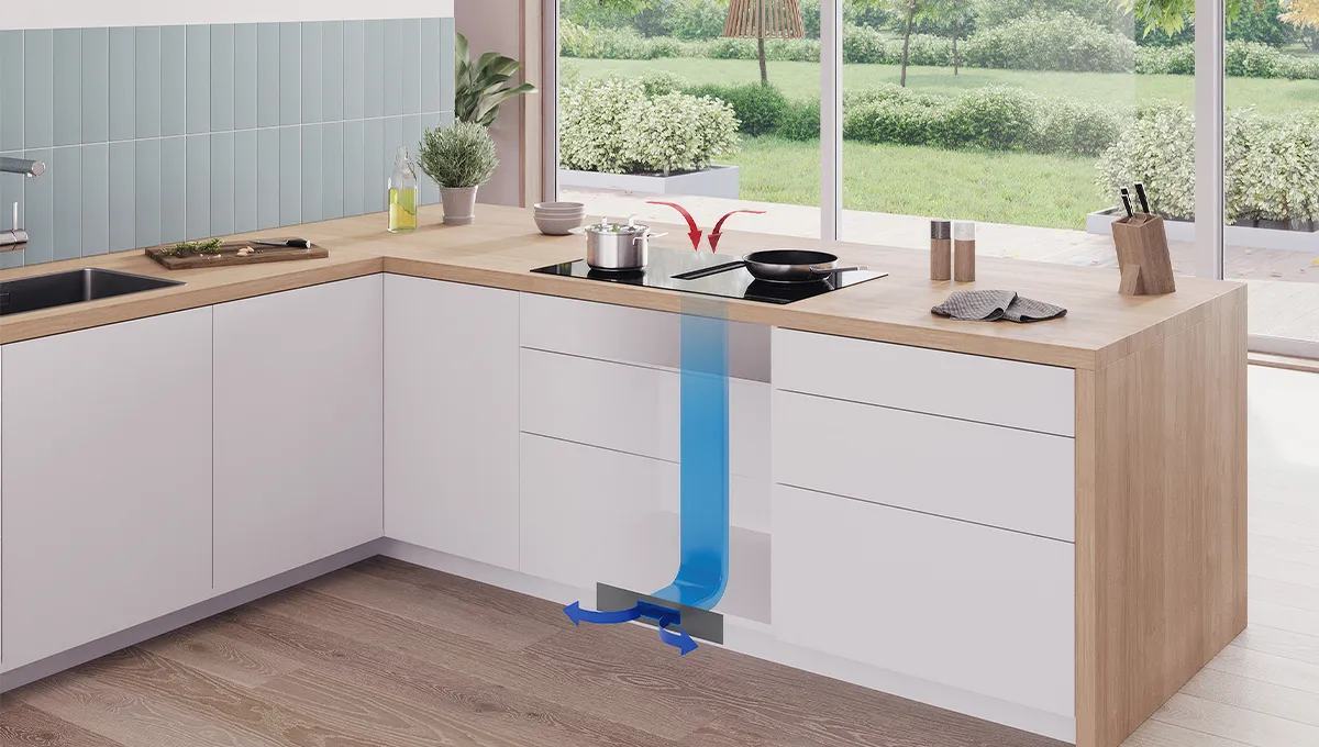 Encimera de inducción Bosch con extractor integrado. La imagen muestra cómo el vapor de las ollas es aspirado hacia abajo y expulsado a través de la base del mueble.