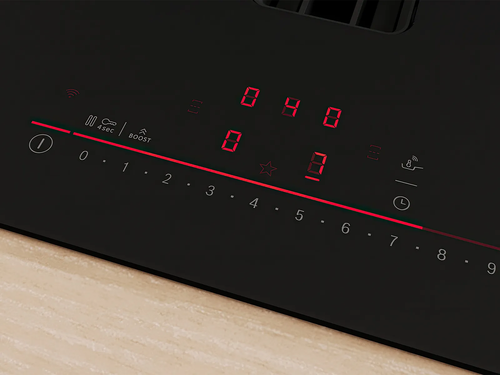 Panel de control táctil de una encimera de inducción negra, con display digital rojo y niveles de potencia del 0 al 9, sobre una cubierta de madera.