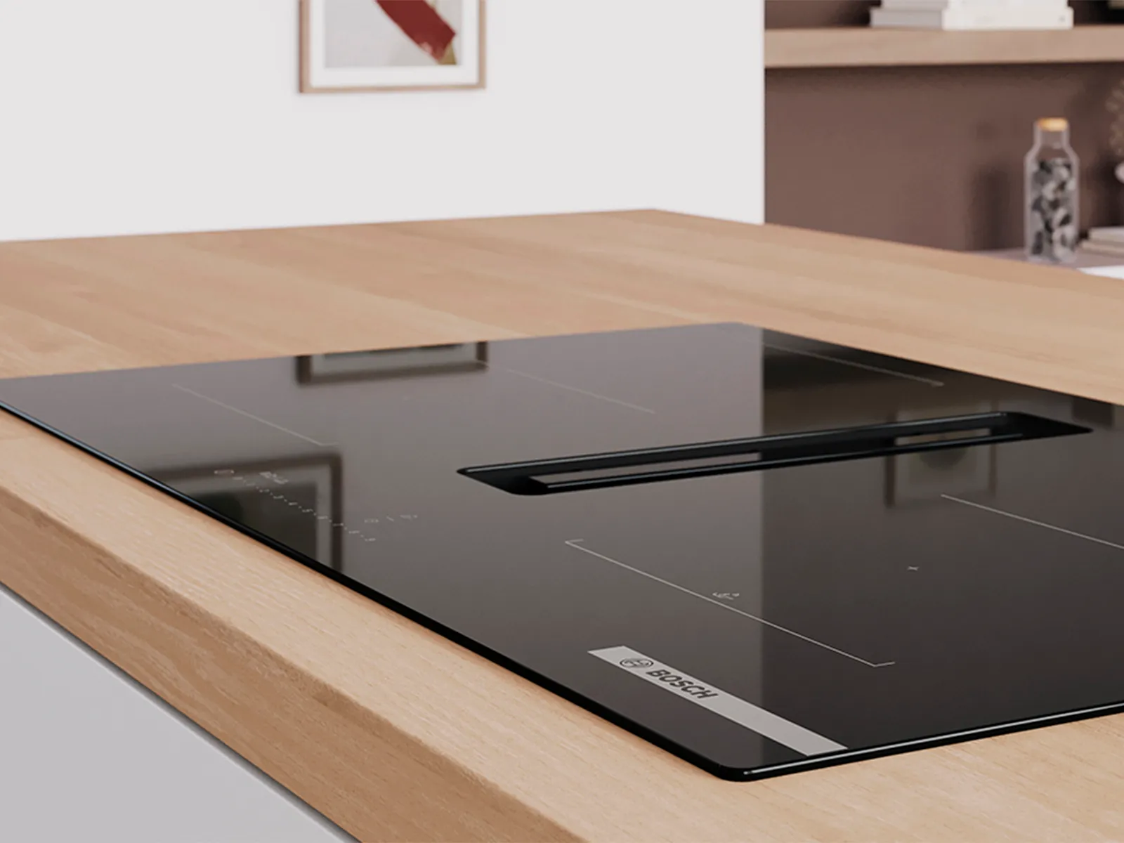Bosch black induction hob with integrated downdraft extractor fan on a wooden countertop in a modern kitchen.