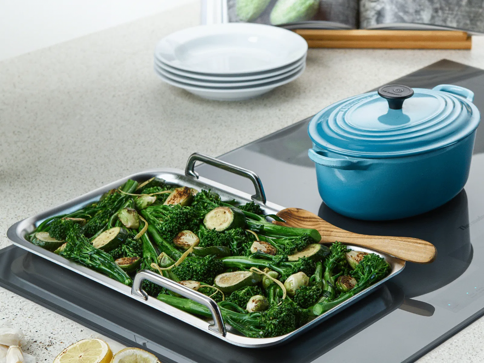 Cooked vegetables on a cooktop, highlighting the island hood's delay shut-off feature.