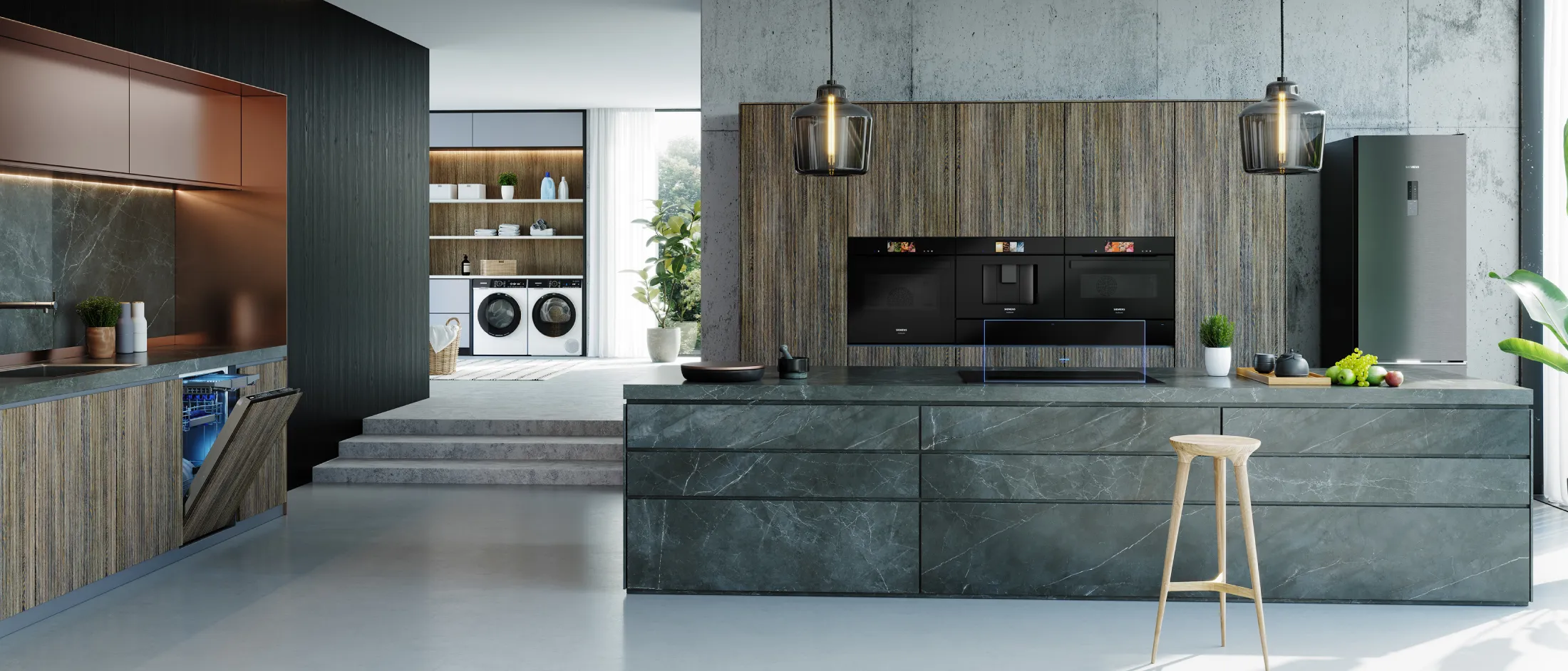 Cucina moderna con elementi in legno e pietra, elettrodomestici da incasso e lampade a sospensione.