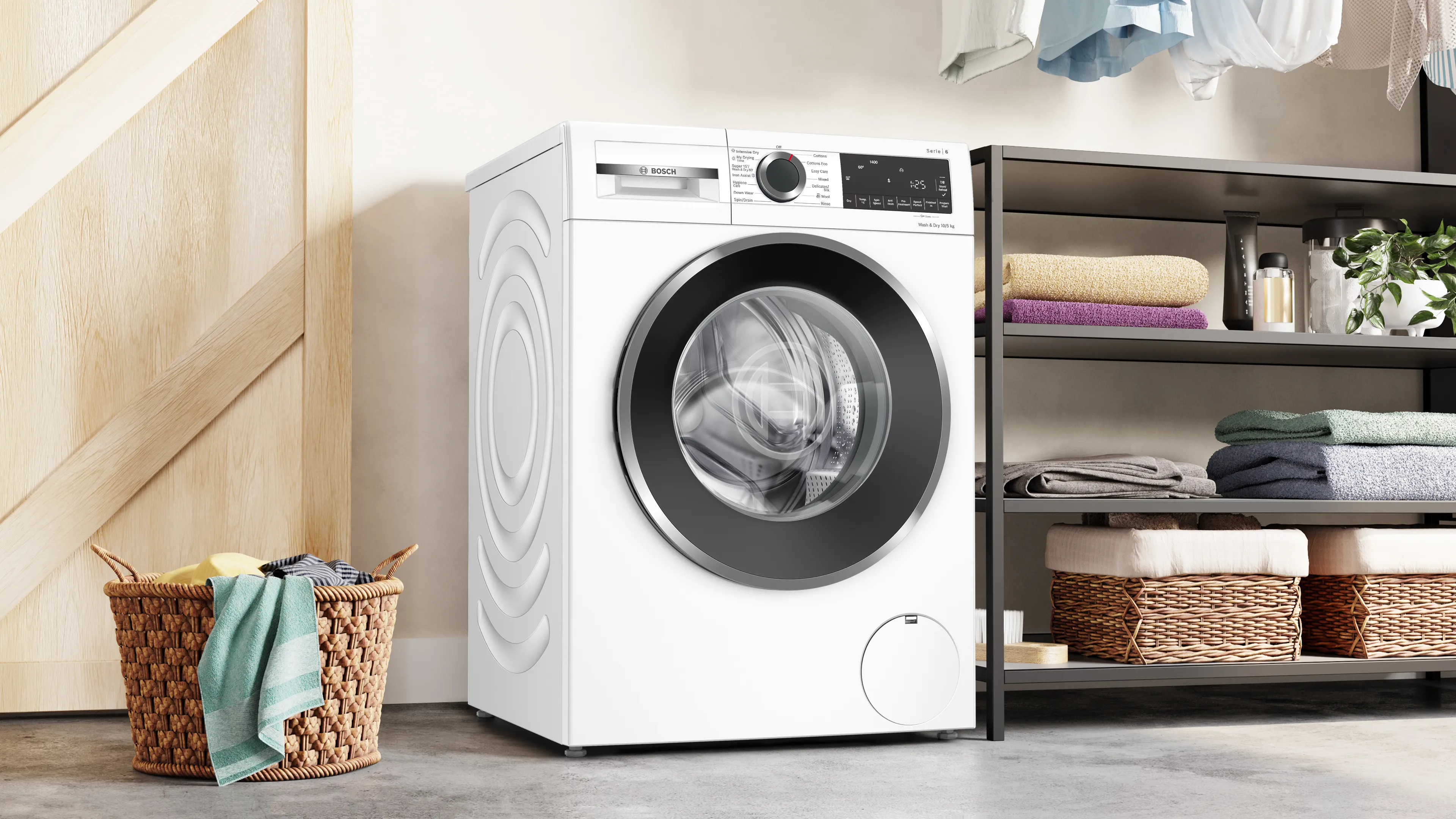 A washer dryer standing in a bright laundry room alongside an open wardrobe containing freshly washed shirts.