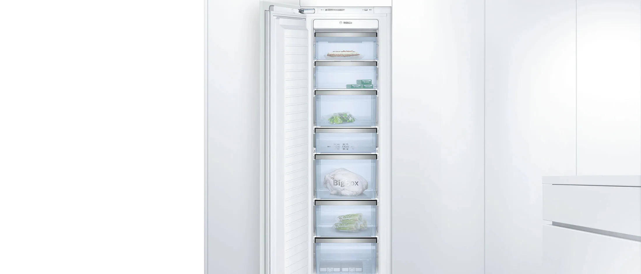 Open freestanding freezer in a bright, modern kitchen.