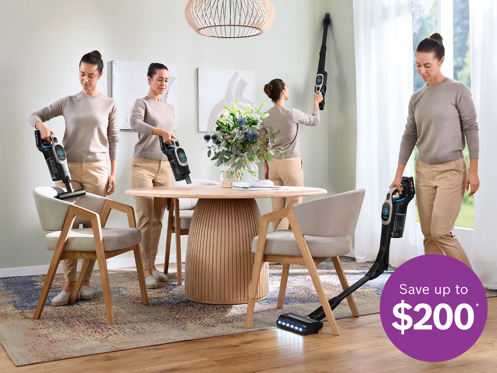 Four men in beige outfits are cleaning and arranging a modern dining room with wooden furniture and plants.
