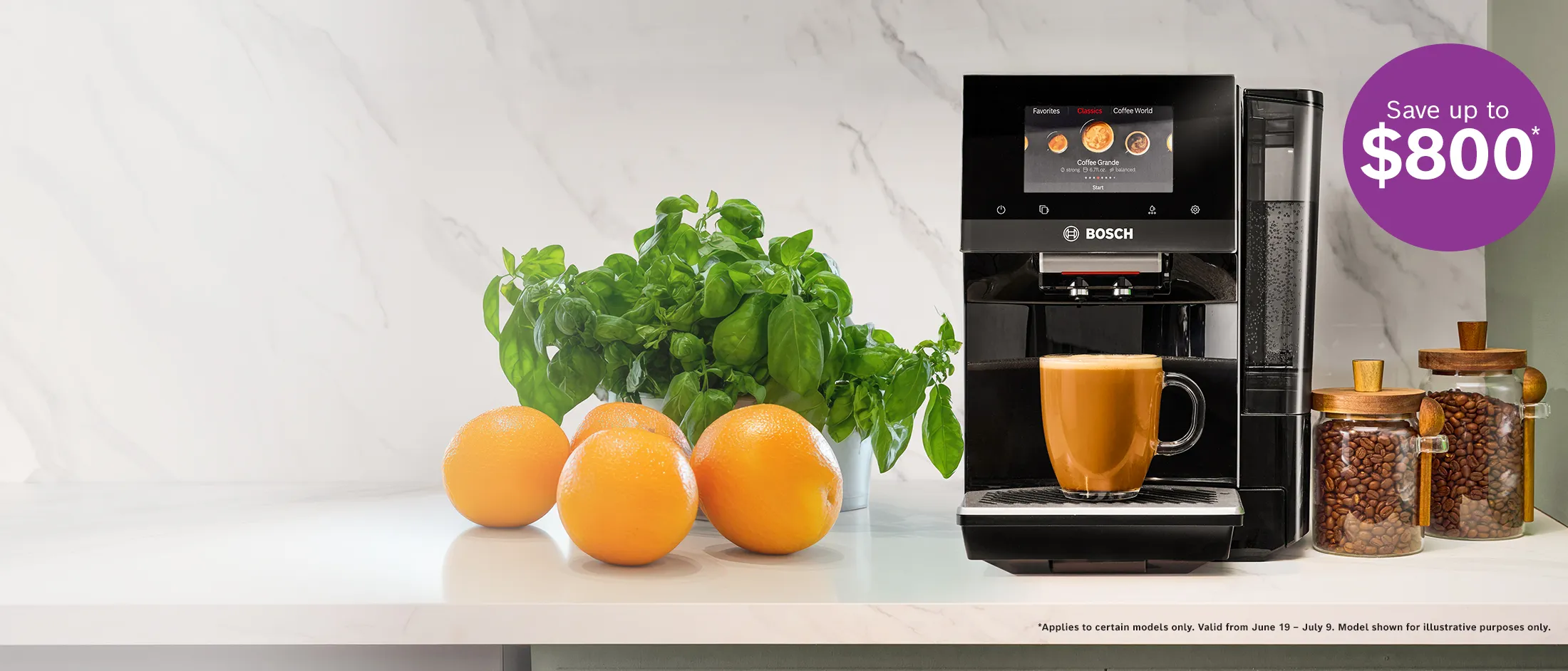 Bosch coffee machine brewing a latte with oranges, basil plant, and jars of coffee beans on a kitchen counter.