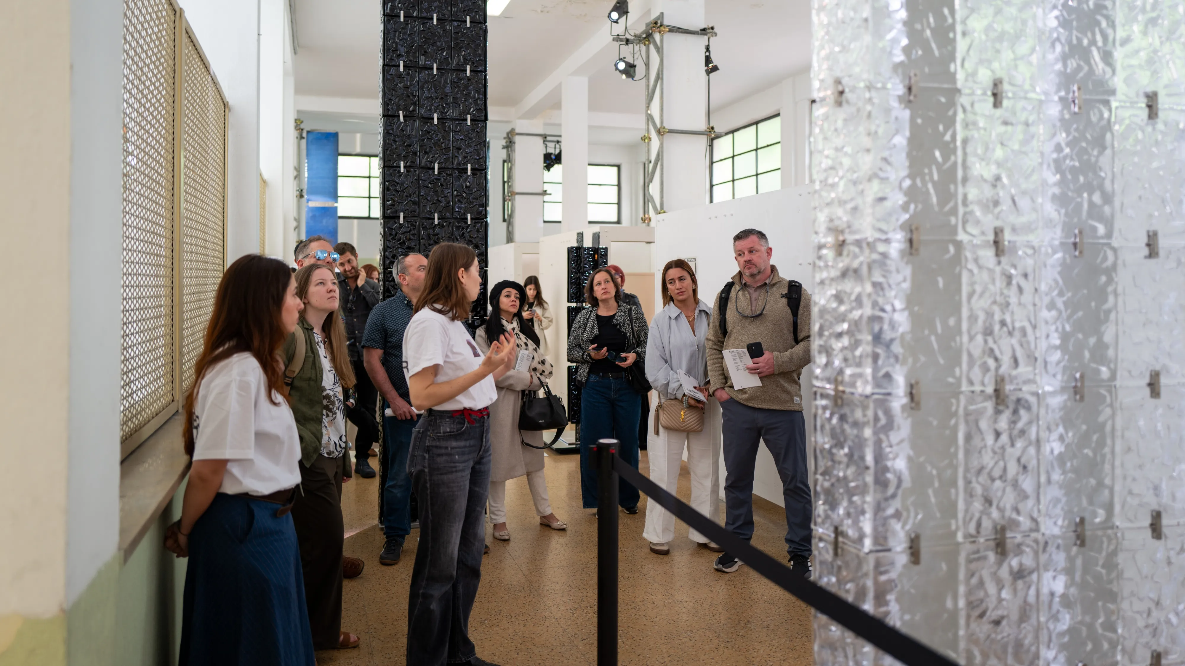 Group members listen to the tour guide in 6:AM’s exhibition space.