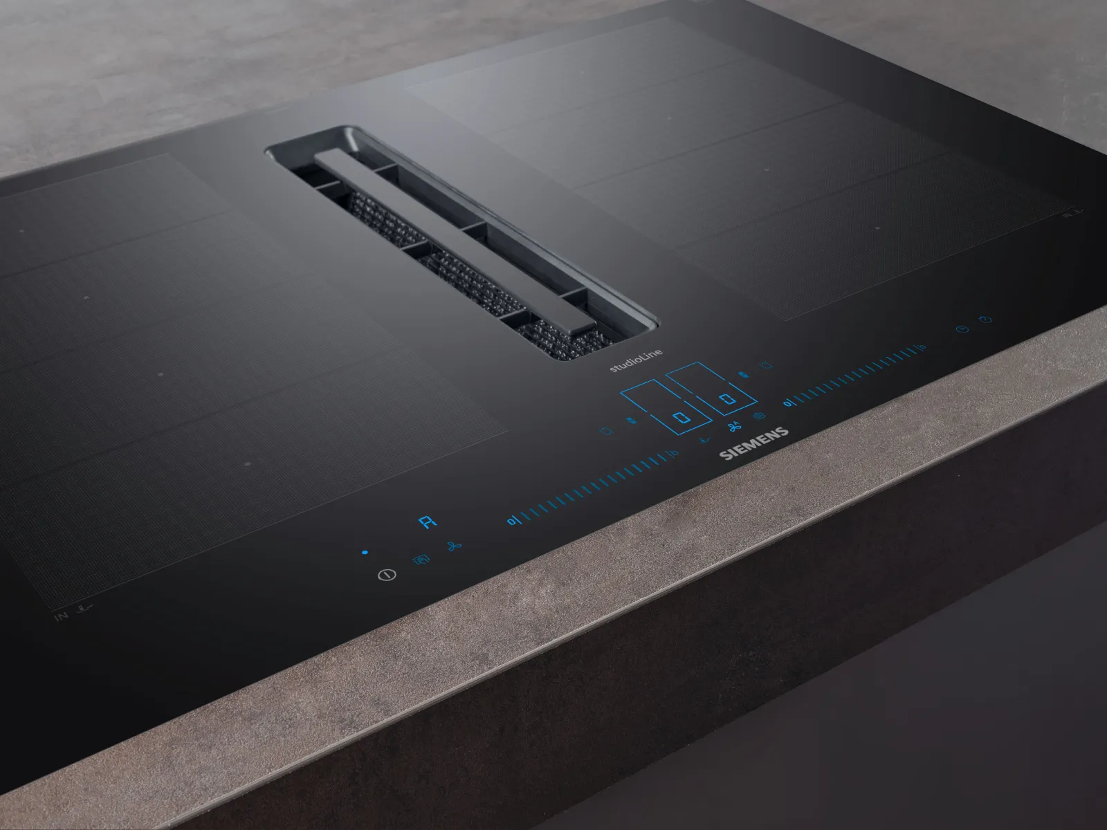 Siemens black glass induction cooktop with built-in downdraft ventilation system and touch control panel on a stone countertop.