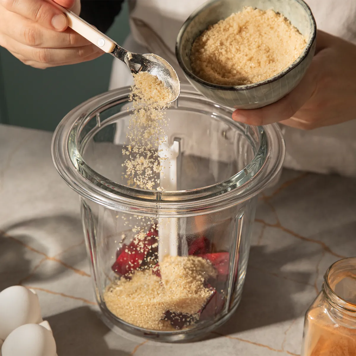Adding brown sugar to beets in a blender. Preparing a sweet Neff recipe with ease.