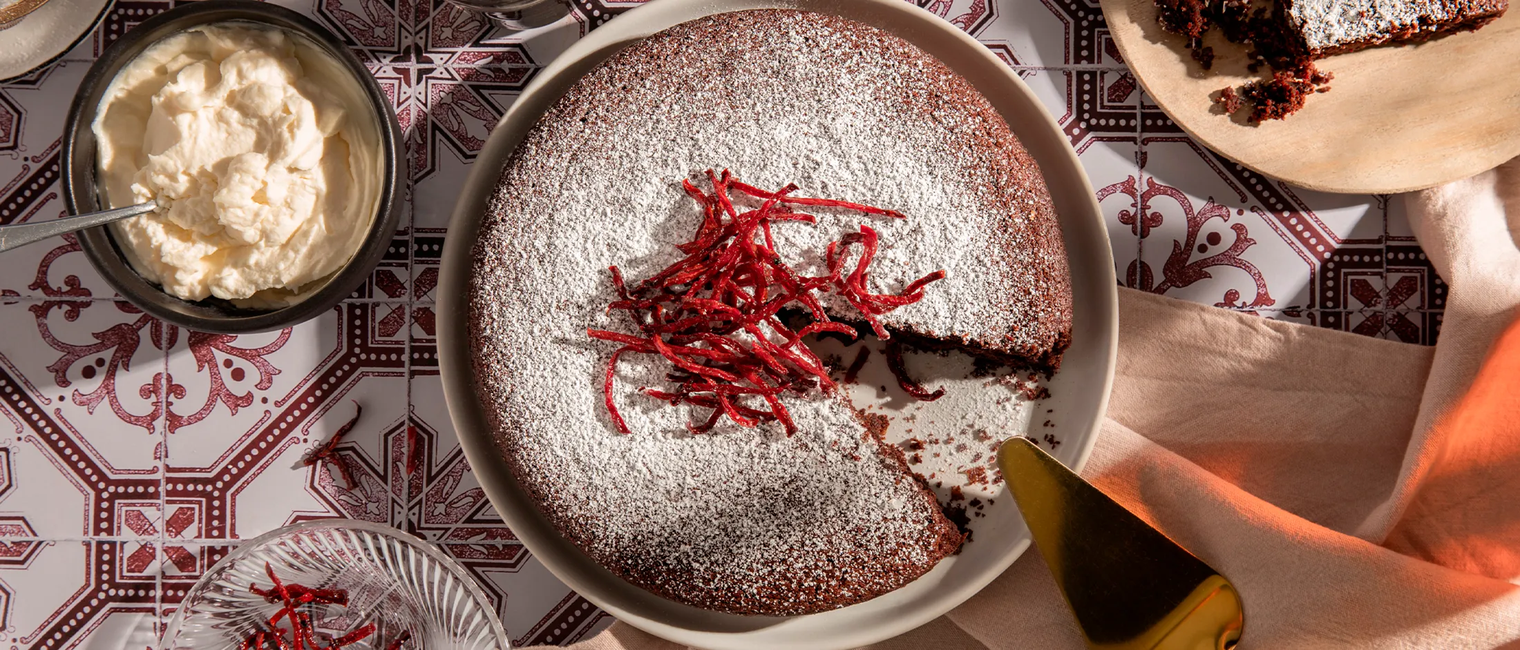 Decadent chocolate cake with powdered sugar & vibrant beet strips, served with creamy topping. Neff's unique dessert.