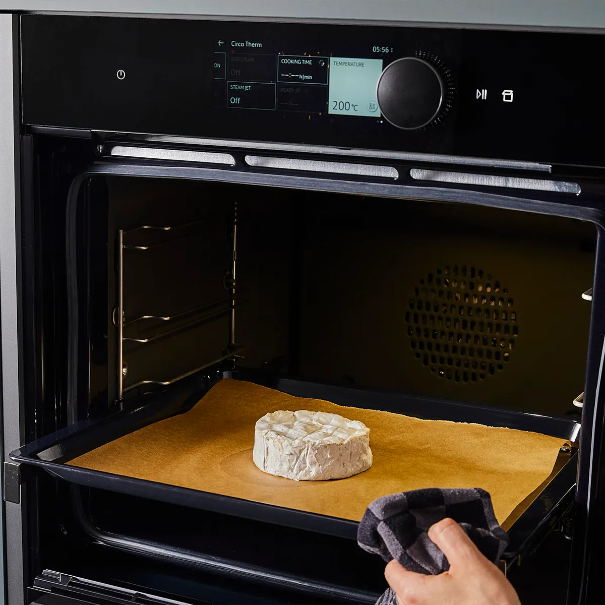 Baking camembert cheese in a Neff oven at 200°C. Precision cooking for gourmet results.