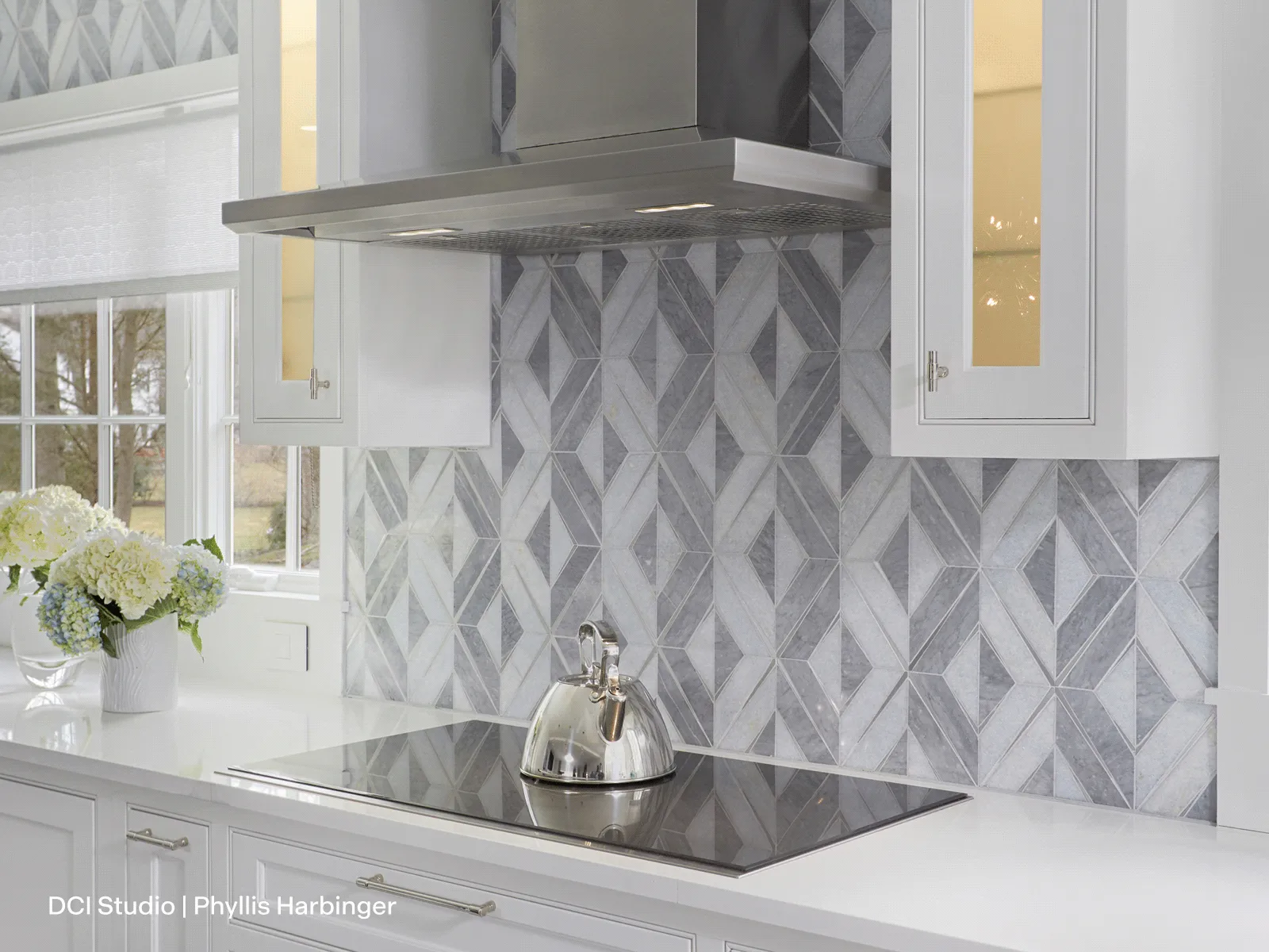 Thermador HMCB36WS 36-inch Masterpiece pyramid chimney wall hood in kitchen with geometric backsplash.