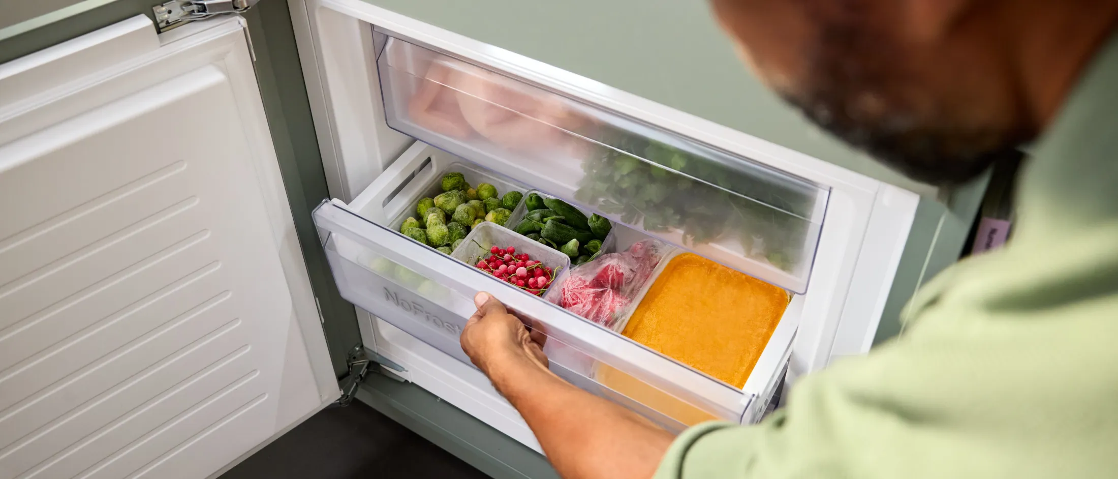 Person öffnet die BigBox-Gefrierschublade einer NEFF Einbau-Kühl-Gefrierkombination mit No Frost.