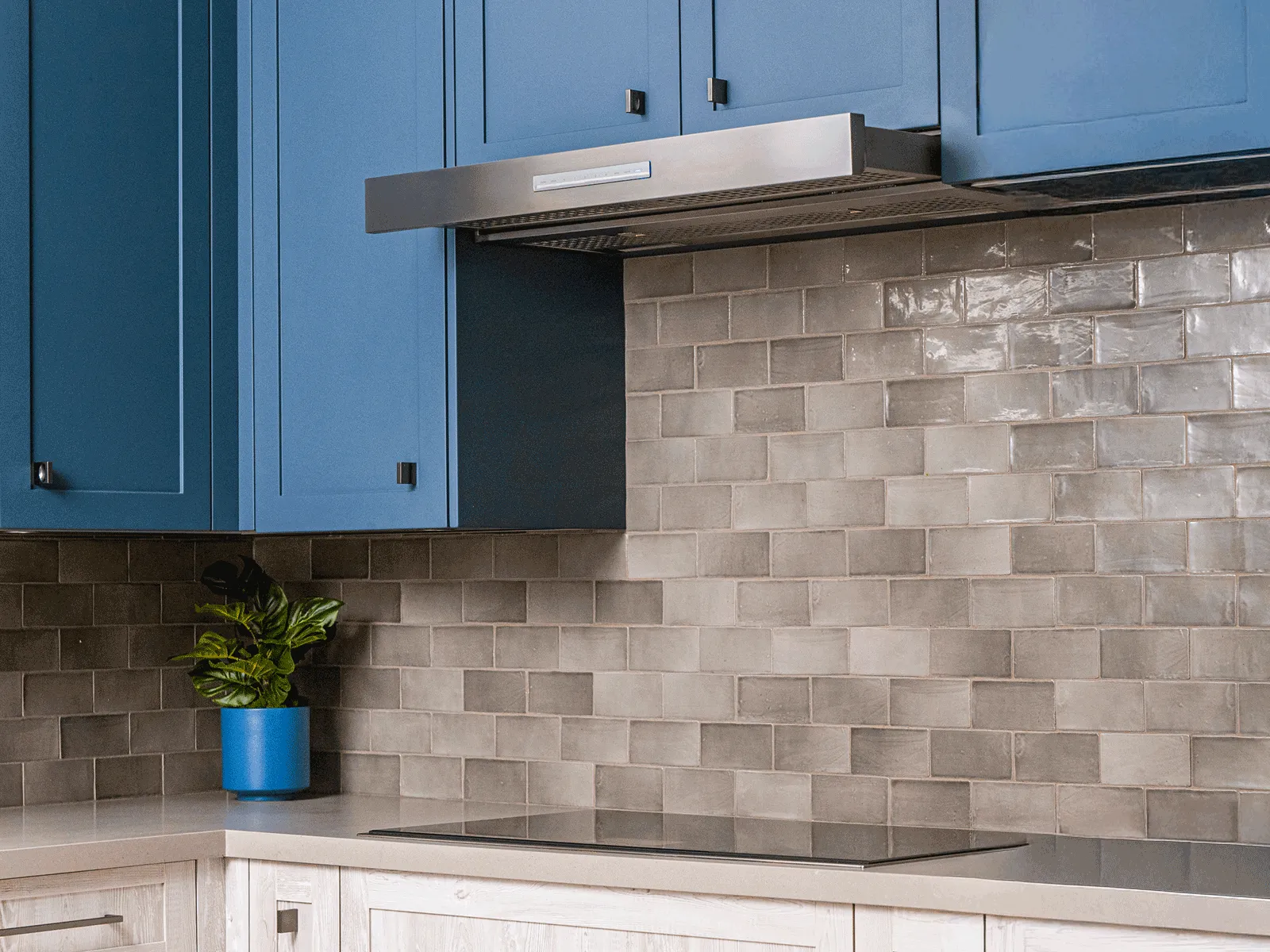 Couple enjoys cooking as their Thermador island hood syncs with the cooktop.