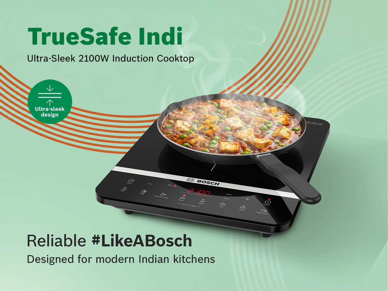 A black Bosch air fryer on a wooden kitchen counter surrounded by fresh vegetables.