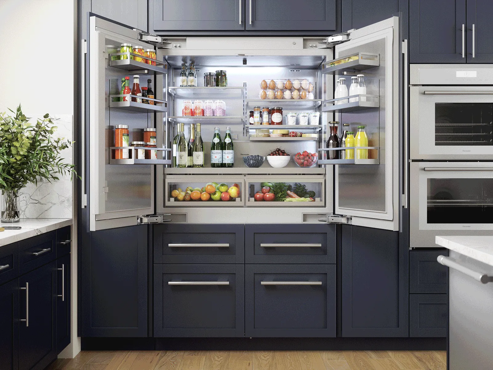 Open French-door refrigerator in a modern kitchen, stocked with fruits, vegetables, beverages, eggs, and condiments.