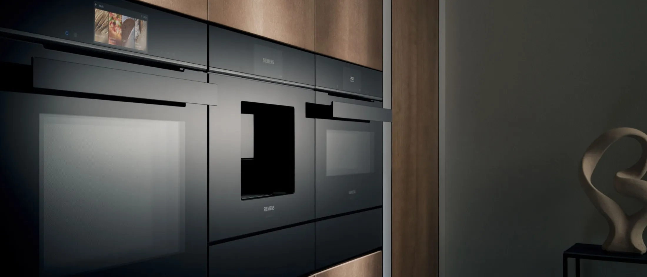 Multiple Siemens built in appliances in dark toned kitchen cabinets