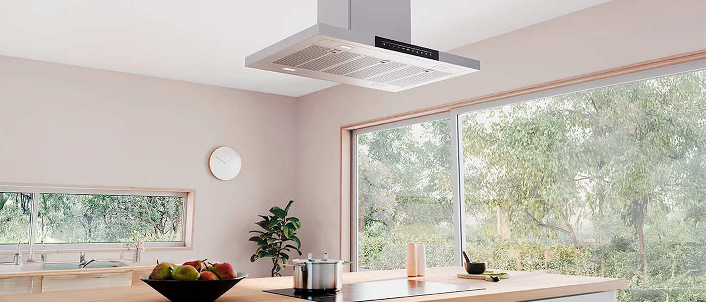Modern kitchen with a sleek ceiling-mounted range hood above a wooden island and large windows.