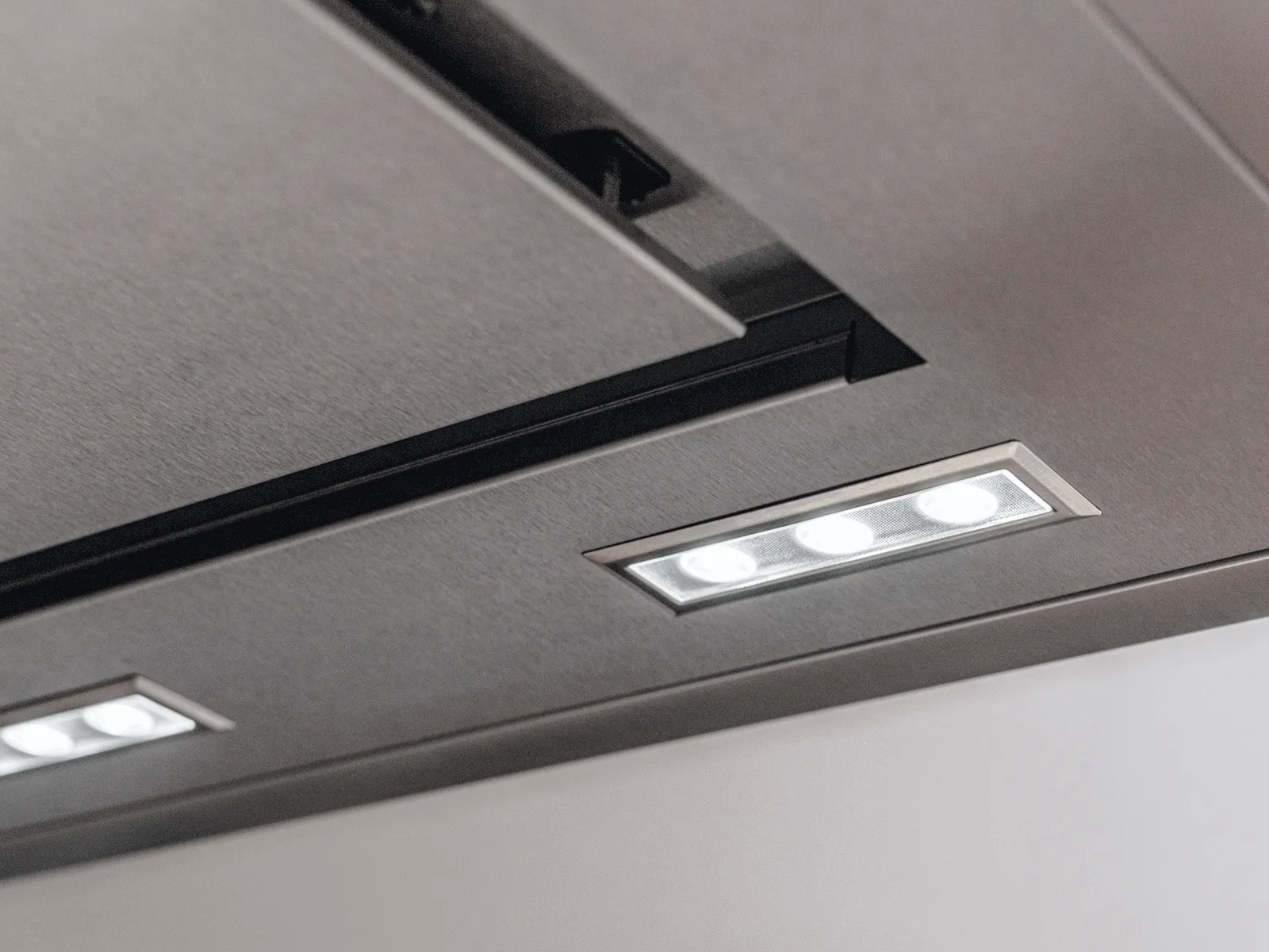 Bright, clean LED illumination from a modern Thermador stainless steel island hood.
