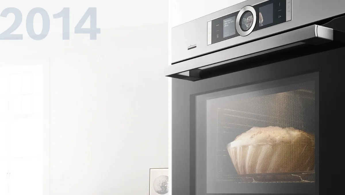 Close-up of a Bosch stainless steel built-in oven with digital display, baking a loaf of bread, 2014.