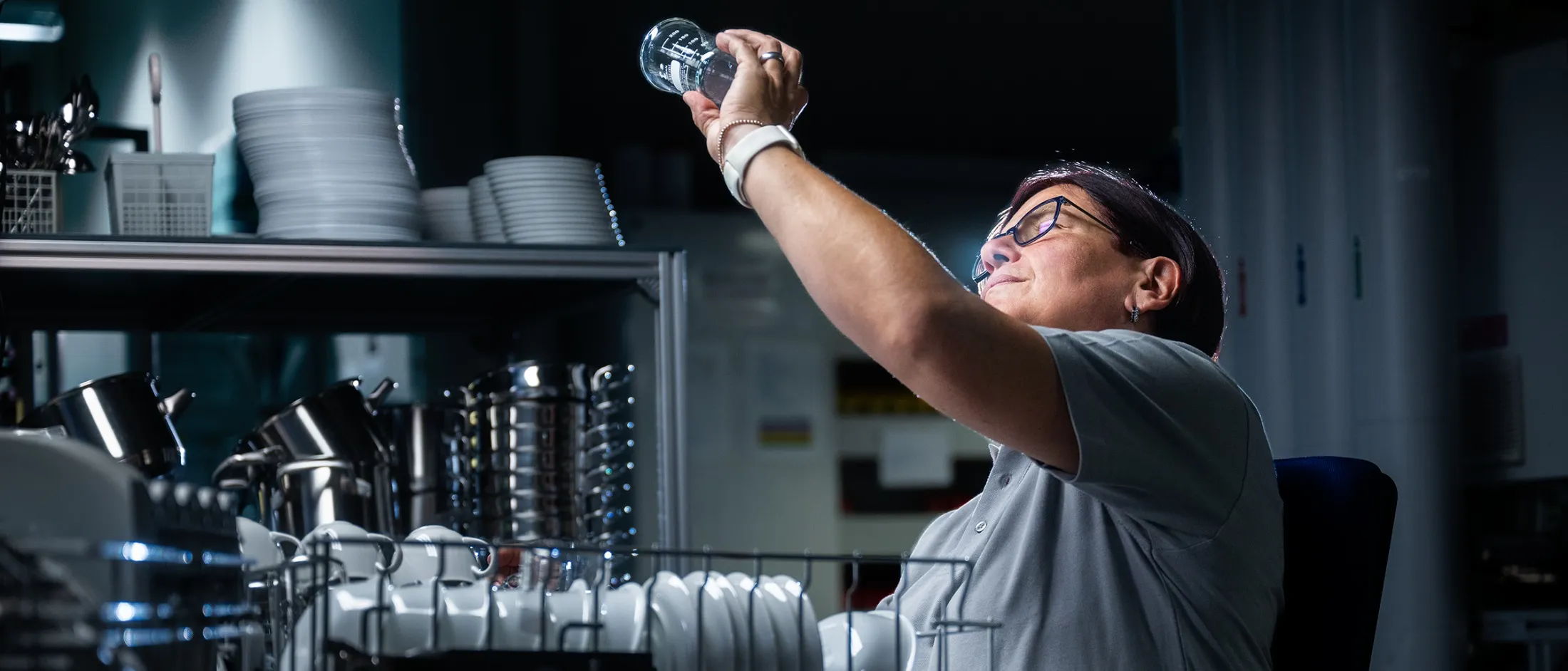Quality employee checking a spotless drinking glass