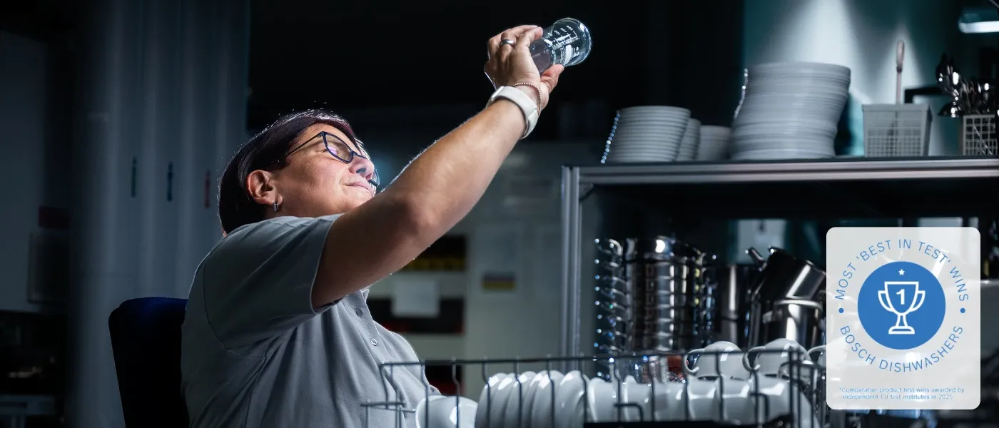 Quality employee checking a spotless drinking glass
