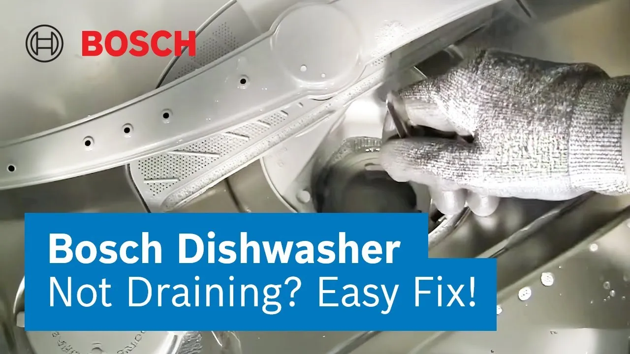 A hand cleaning a spray arms in dishwasher.