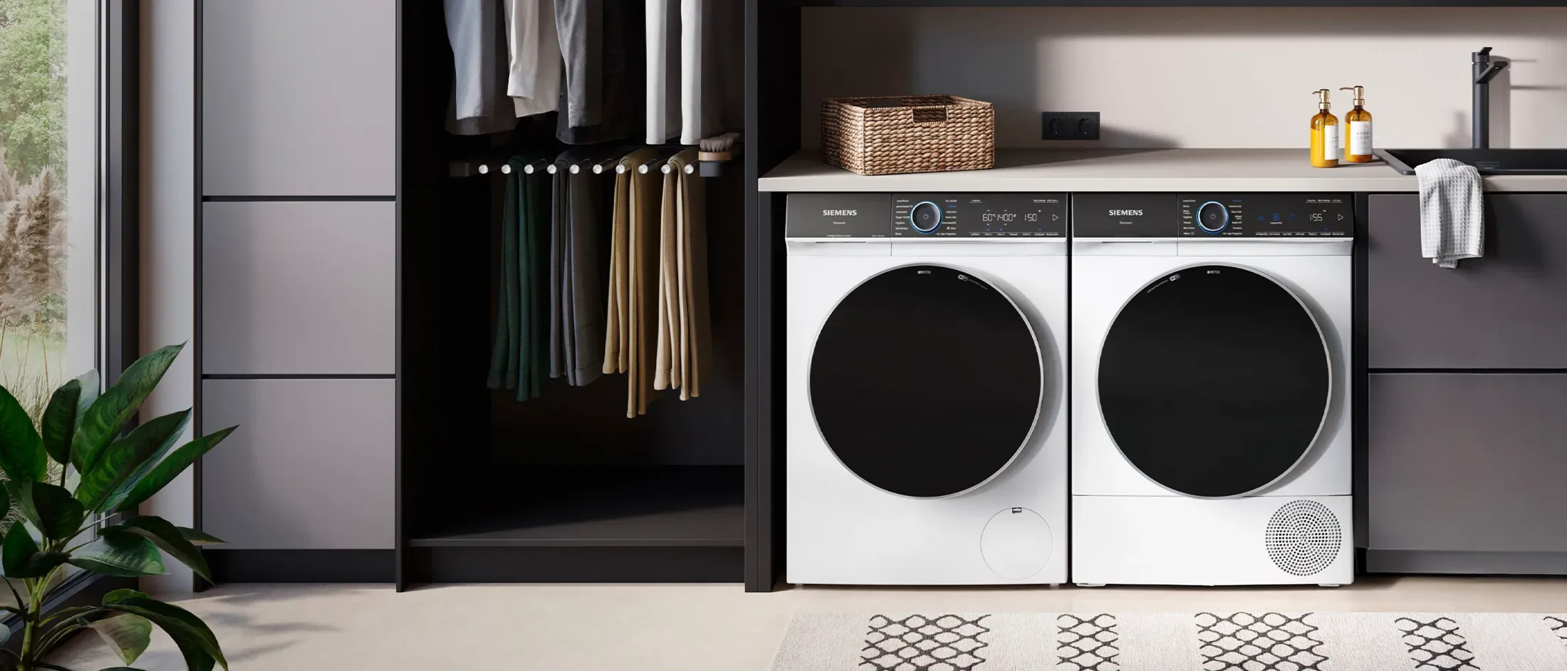 Modern laundry room with award-winning washer and dryer, shelves with towels, and clothes hanging.