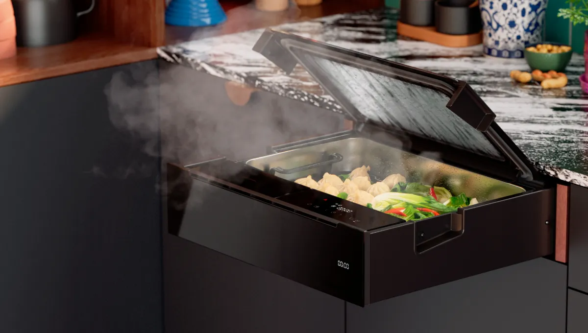 Built-in kitchen steamer with an open lid, steaming dumplings and vegetables.