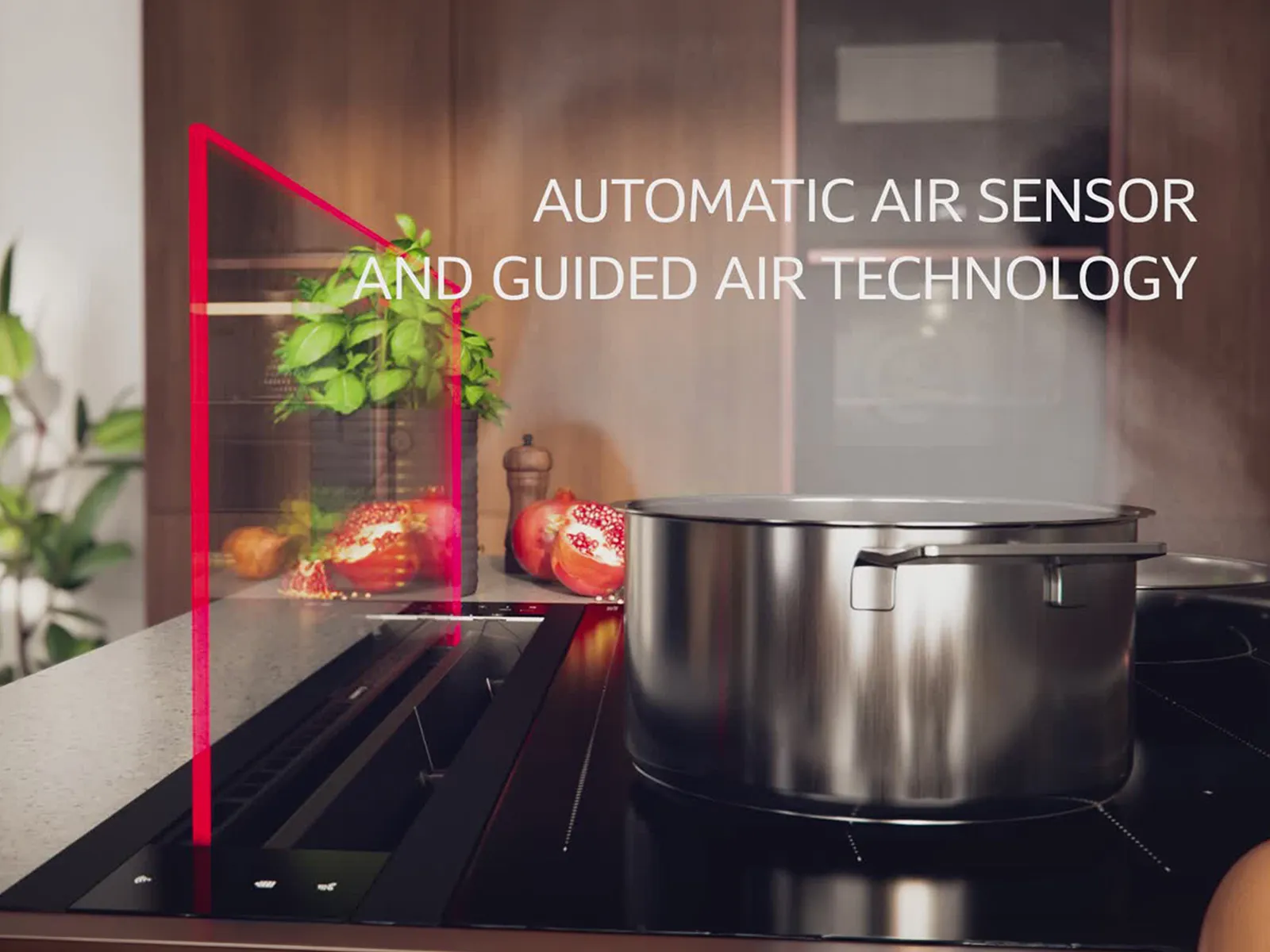 Готварски плот с Automatic Air Sensor, кухненски уреди, растения и бутилка със зехтин.