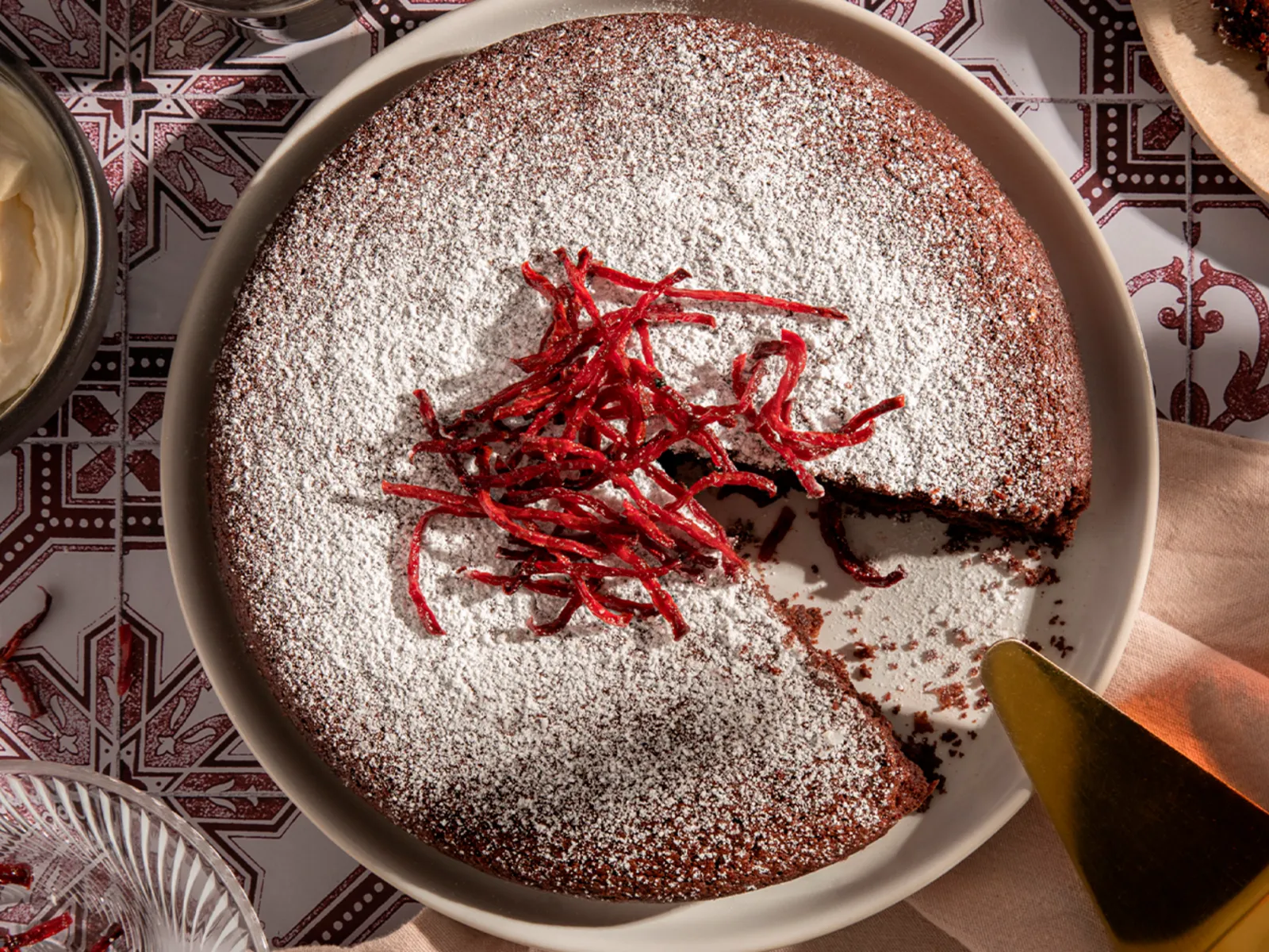 Decadent chocolate cake with powdered sugar & vibrant beet strips, served with creamy topping. Neff's unique dessert.