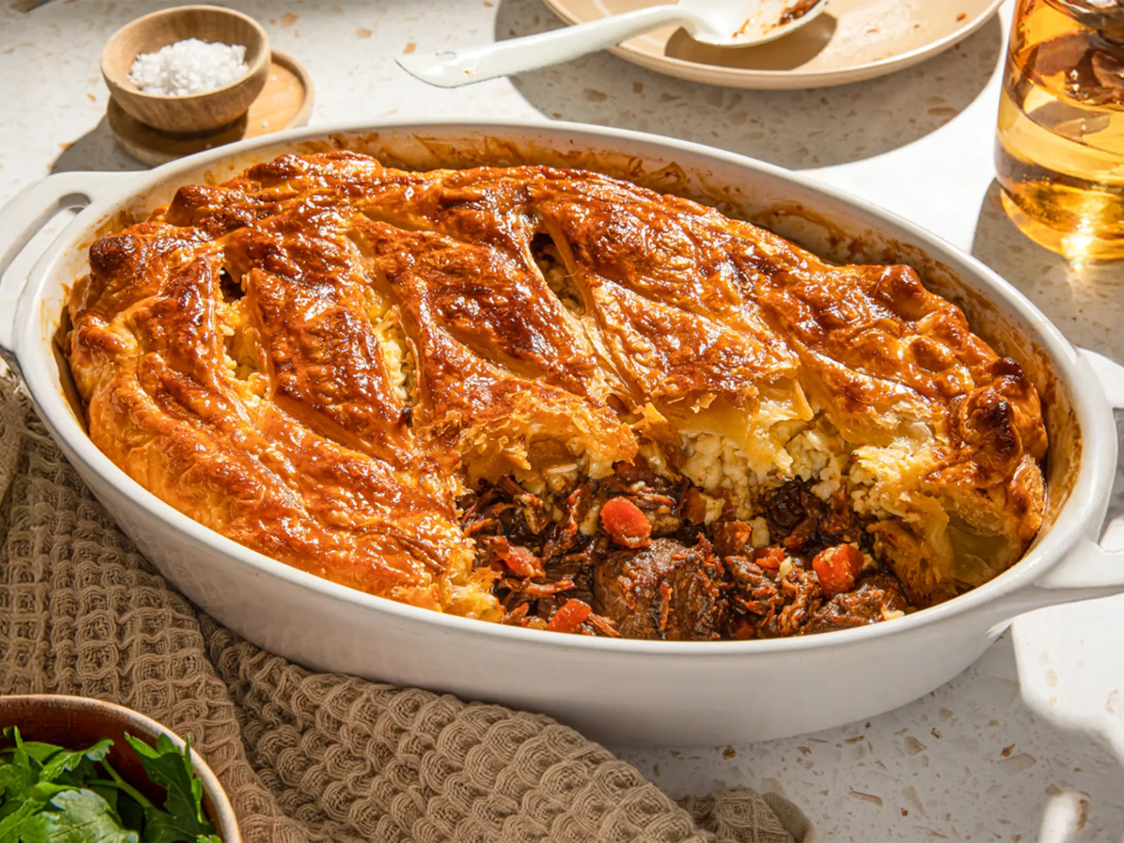 Baked casserole dish with savory meat, vegetables, and a golden-brown crust.