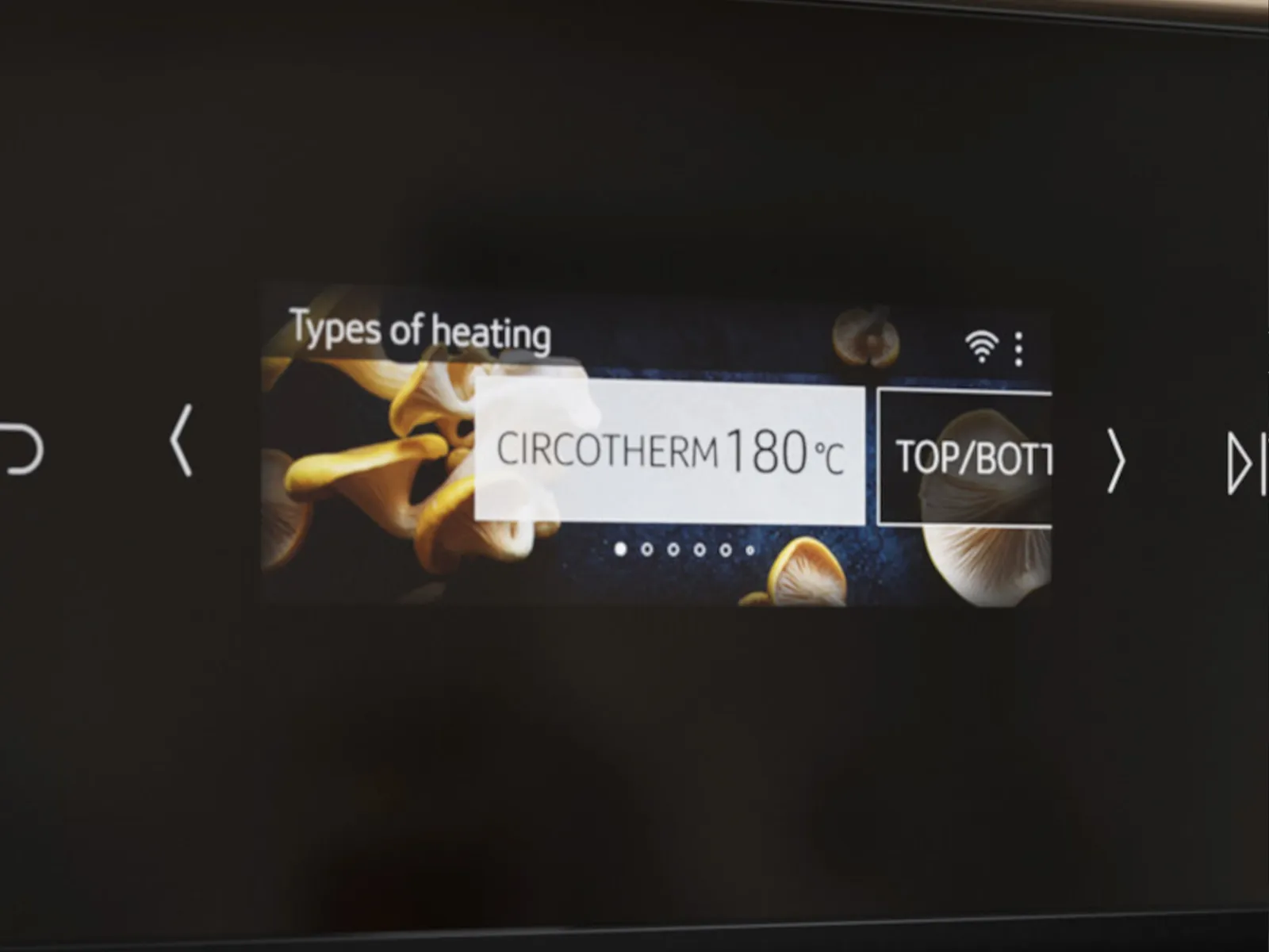 Close-up of a Neff oven digital display showing heating type set to "Circotherm" at 180°C with top/bottom heat selected.