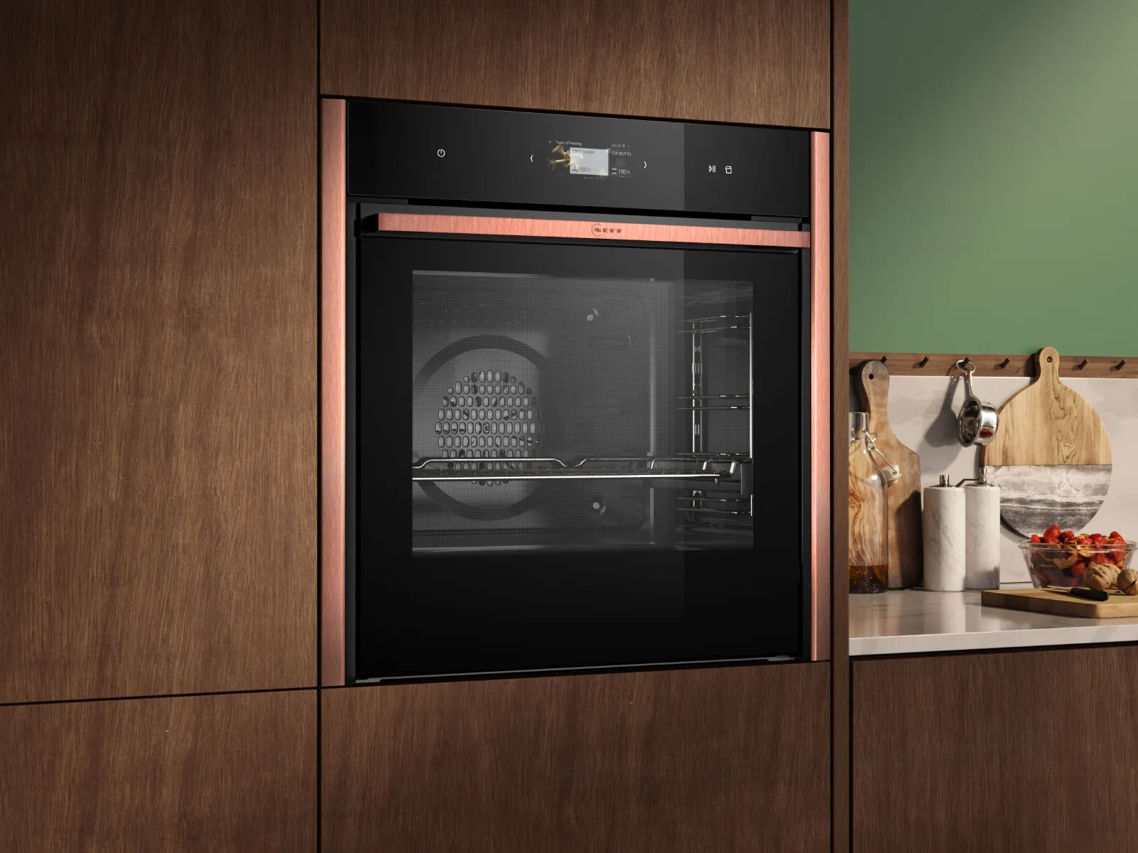 A bright green kitchen featuring a sleek black oven, showcasing a modern and vibrant cooking space.