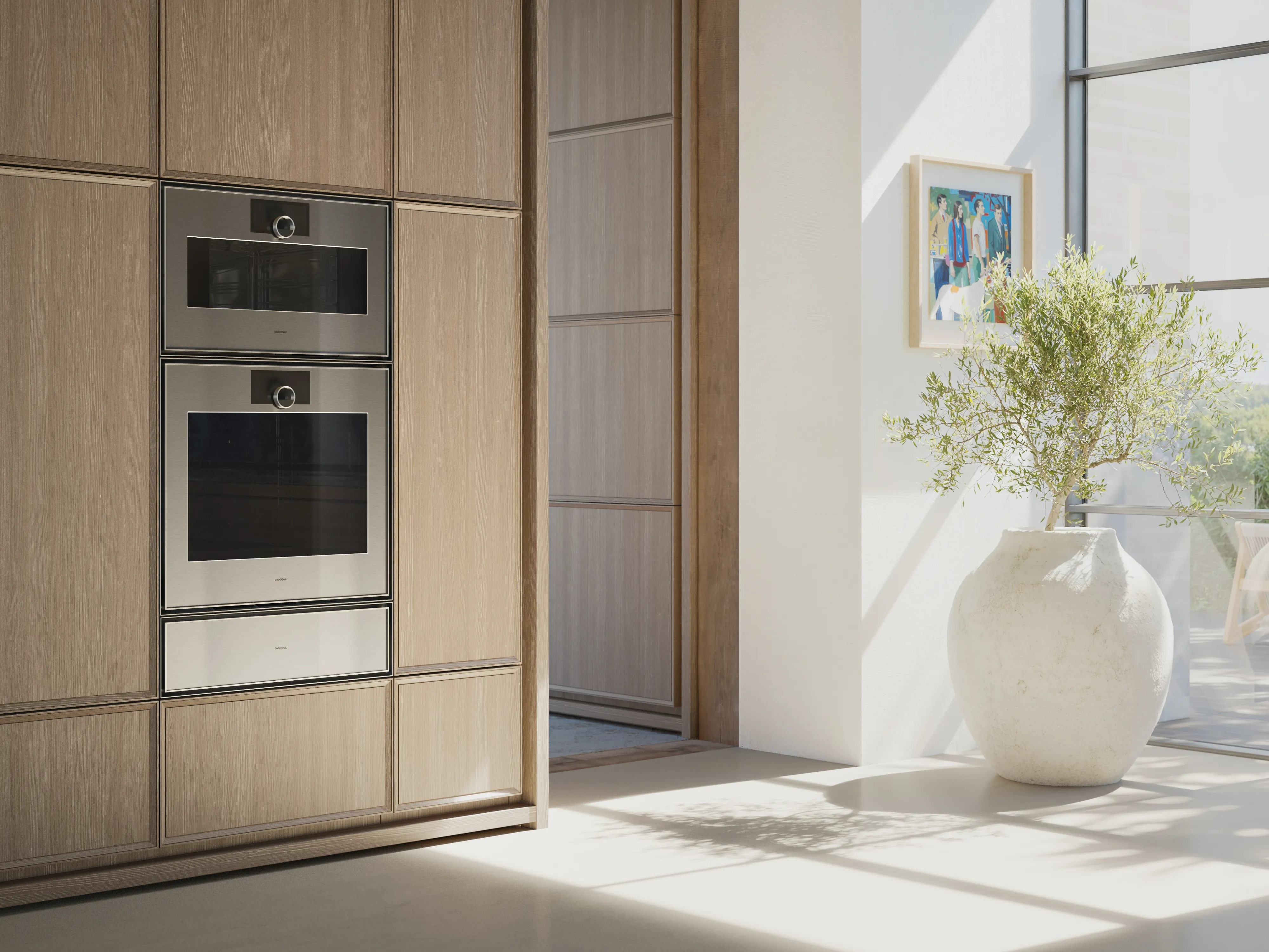 View into an open plan luxury kitchen fitted with Gaggenau Expressive series appliances