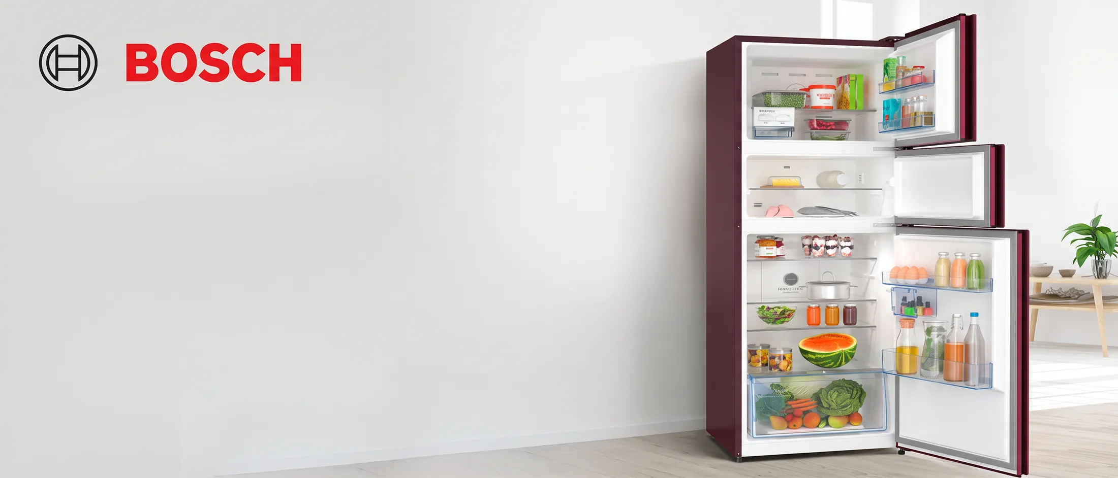 An open Bosch refrigerator showcasing its Max Flex feature with three cooling zones, filled with various food items, alongside text "Max Flex 3 Cooling Zones. 1 Fridge." and the Bosch logo.