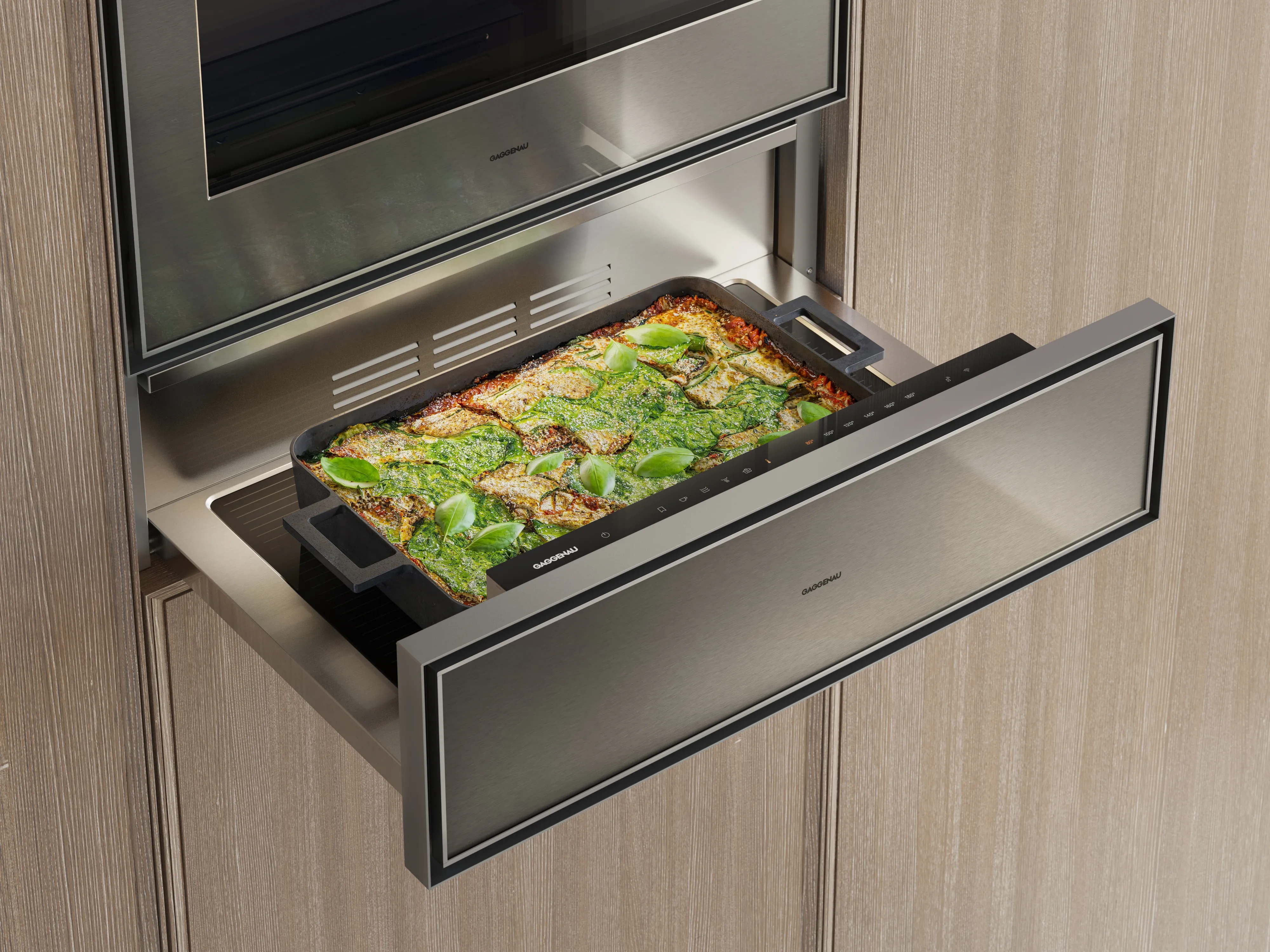 Close-up image of an open Gaggenau Expressive series culinary warming drawer containing a lasagna