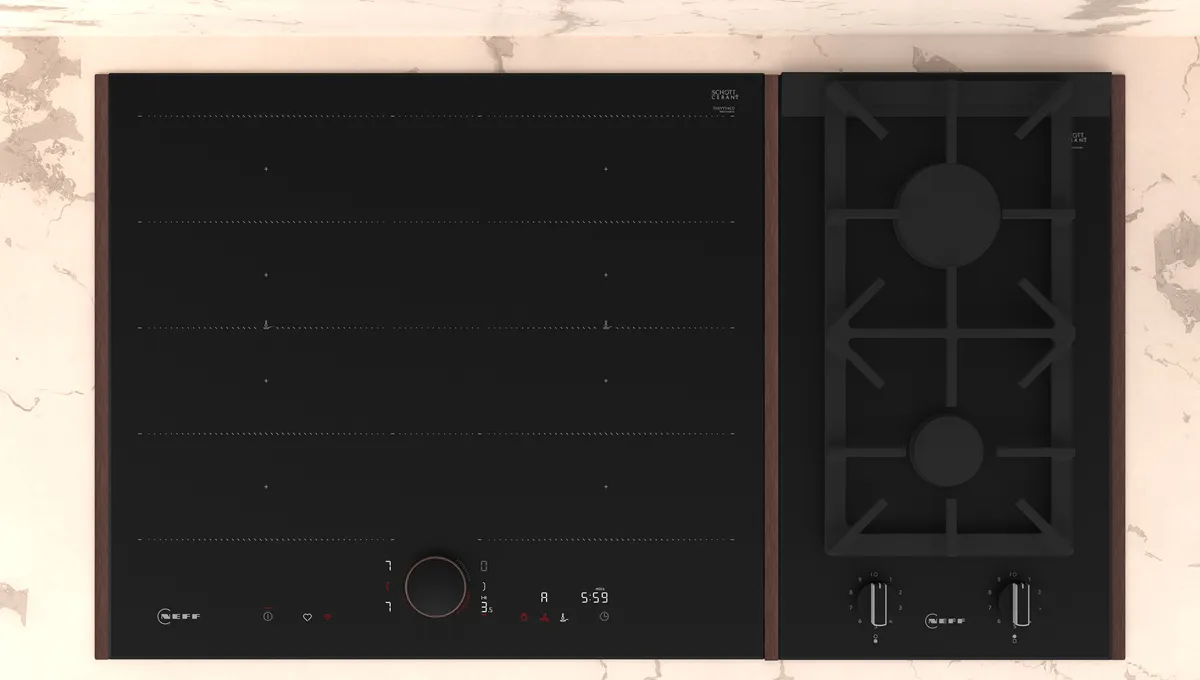 Dual-surface cooktop with induction and gas burners on a marble-patterned background.