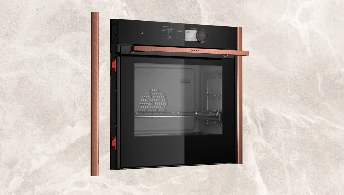 Black built-in oven with glass door and wooden trim, modern kitchen appliance.