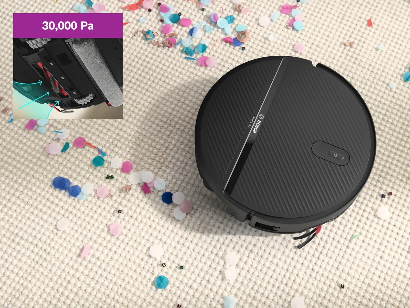 Spotless 2 on a white carpet, clearing a path through confetti, showcasing its suction power.