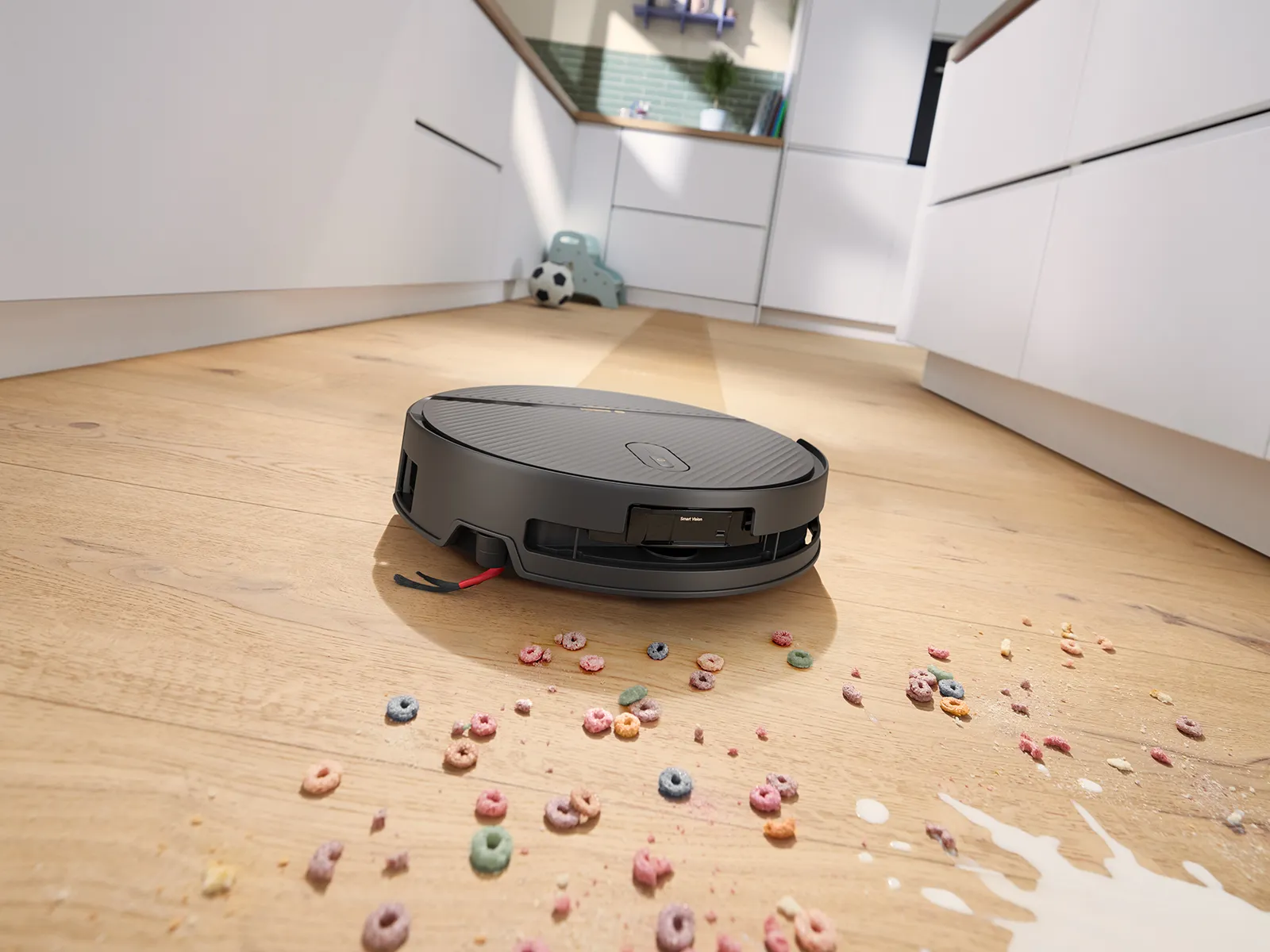 Spotless 2 Advanced approaches spilled milk and colorful cereal scattered across a wooden kitchen floor.