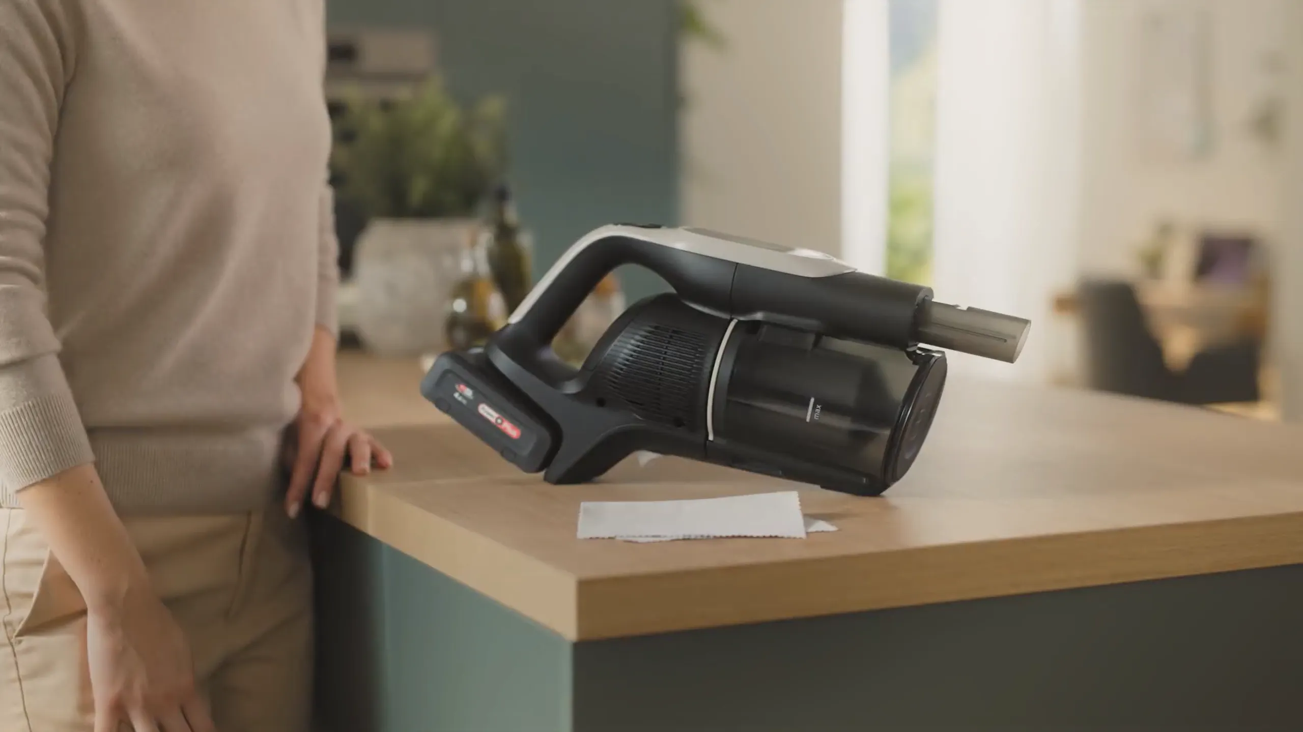 Bosch Cordless Vacuum resting on countertop with man to the side