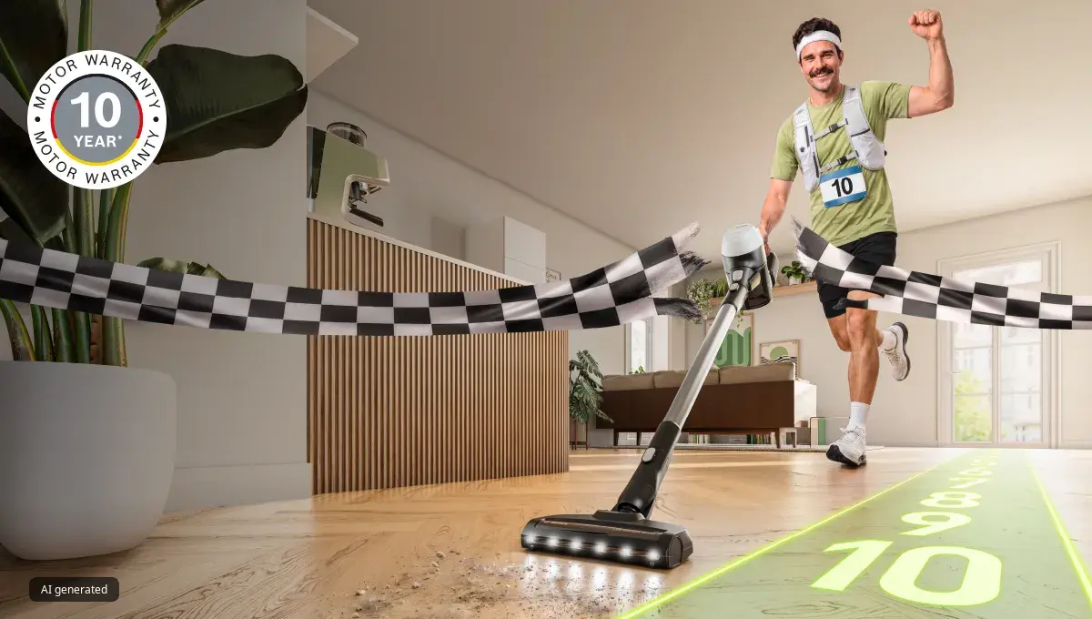 Unlimited 5 stick vacuum with LED nozzle crosses finish line on wood floor. Triumphant runner & "10 YEAR MOTOR WARRANTY" badge, emphasizing durability