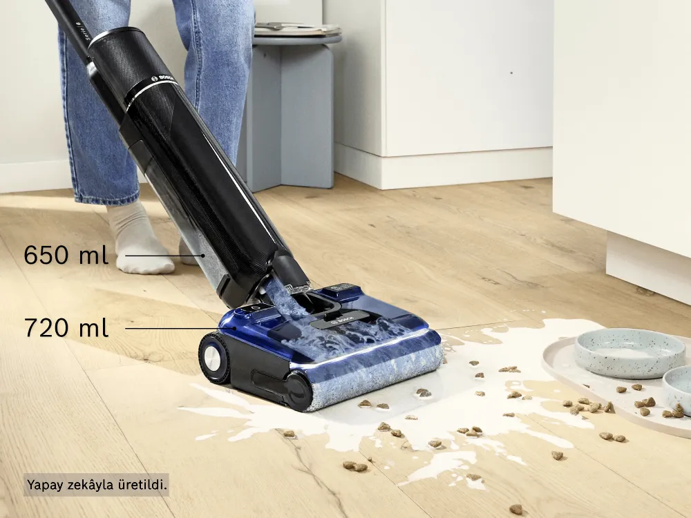 A person uses the Bosch Floor Washer to clean up spilled milk and cat food, showcasing how the Floor Washer cleans wet surfaces.