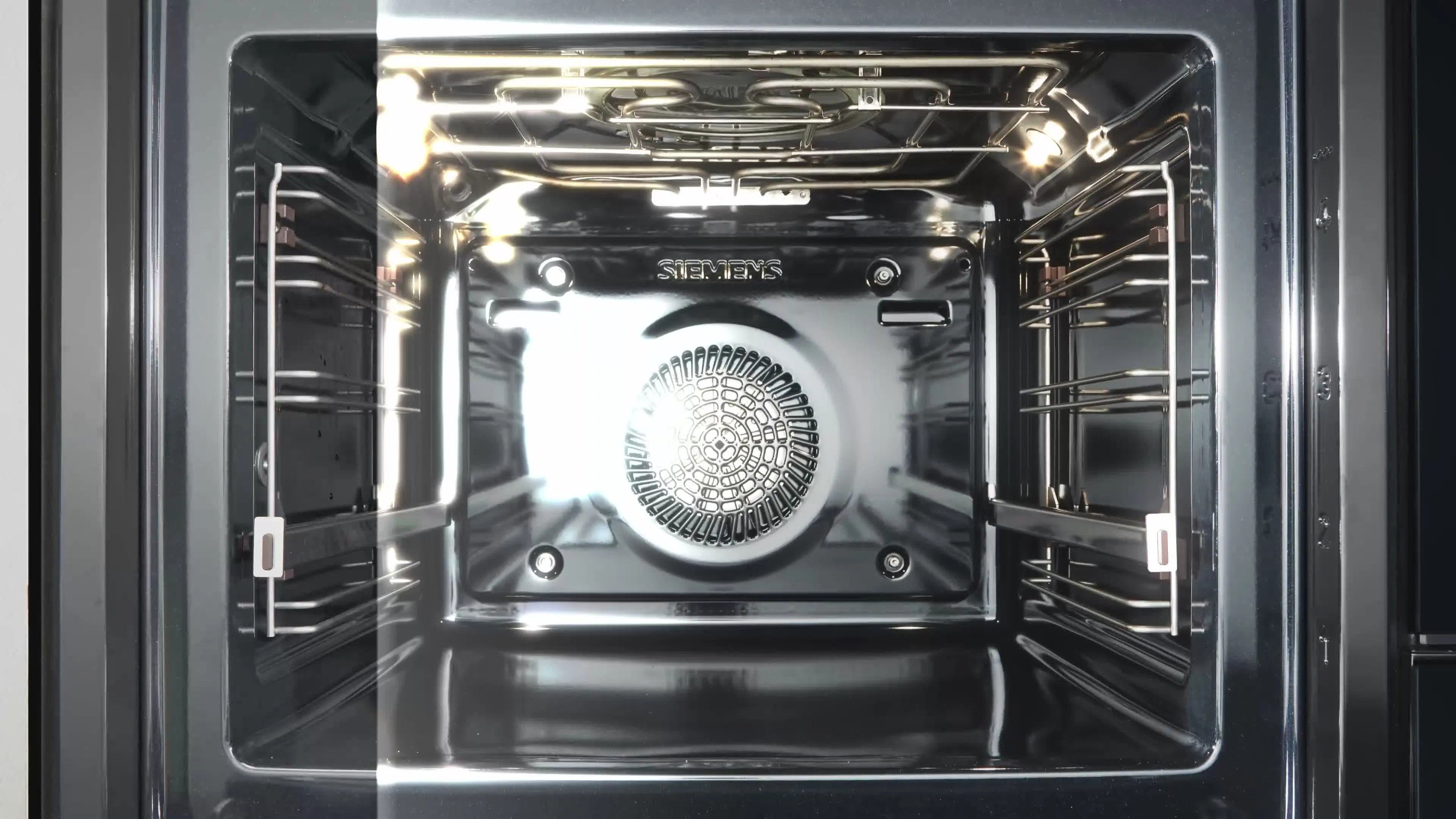 Interno di un forno elettrico pulito con ventola posteriore e illuminazione accesa