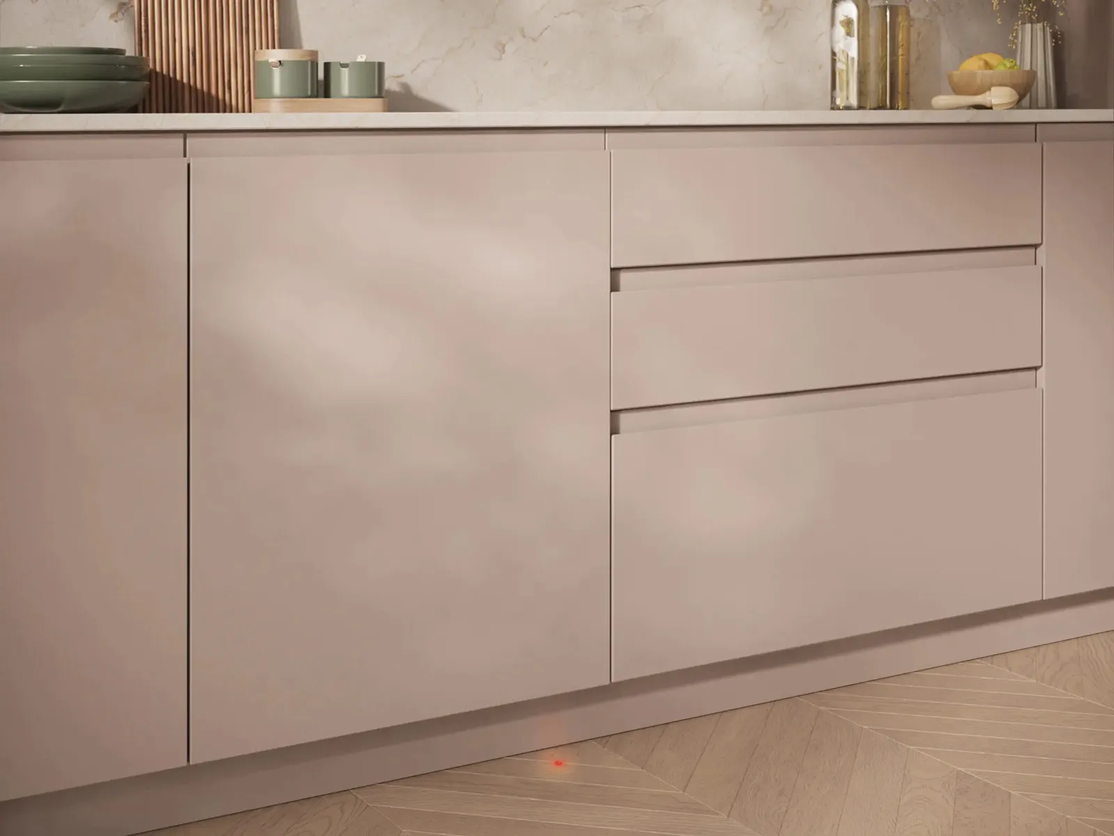 Moderne beige Küchenschränke mit einer Rückwand aus Marmor, Holzschneidebrettern, Olivenölflaschen und Trockenblumen auf der Arbeitsplatte.