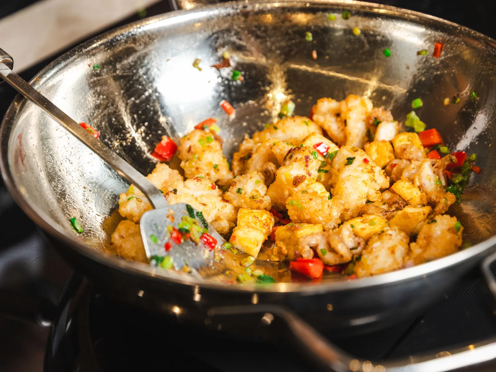 Siemens induction hob to prepare Salt & Pepper Squid & Tofu on Caesar Salad