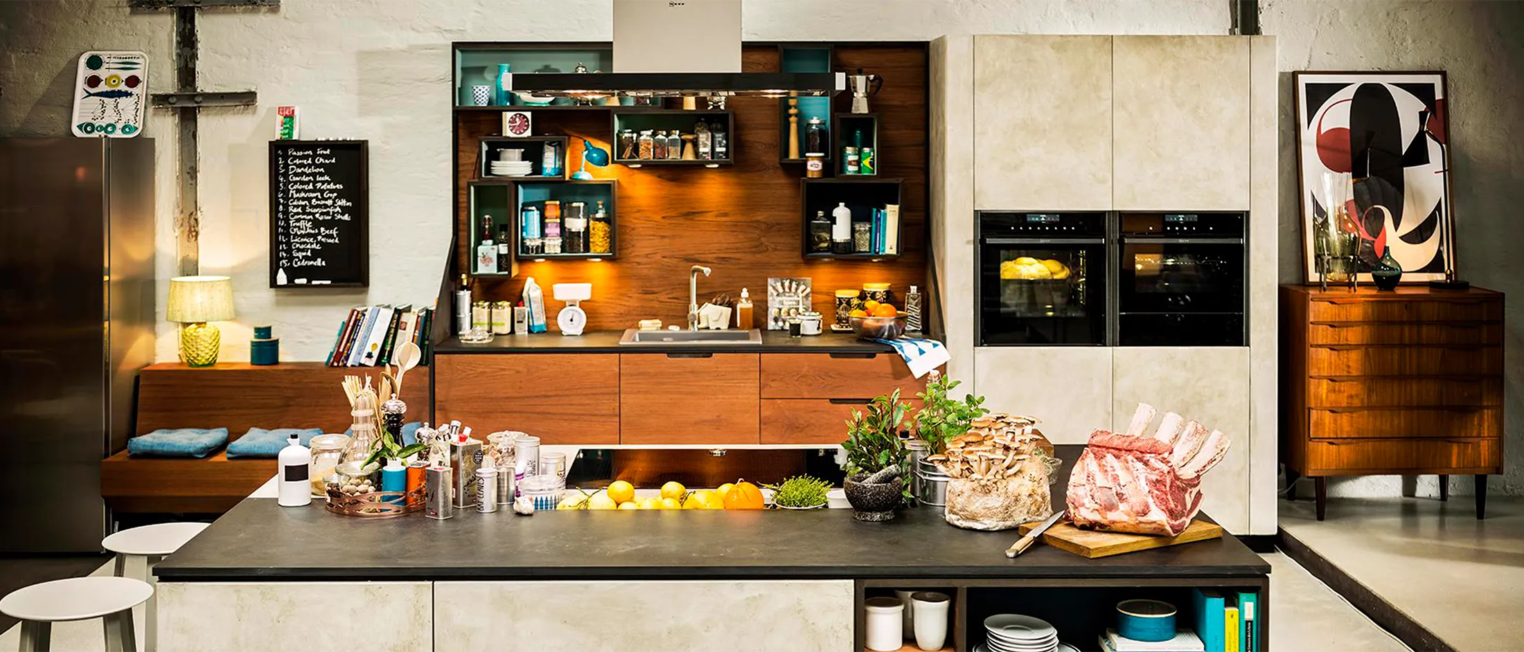 Modern kitchen with wooden cabinets, appliances, and cooking utensils on a countertop.
