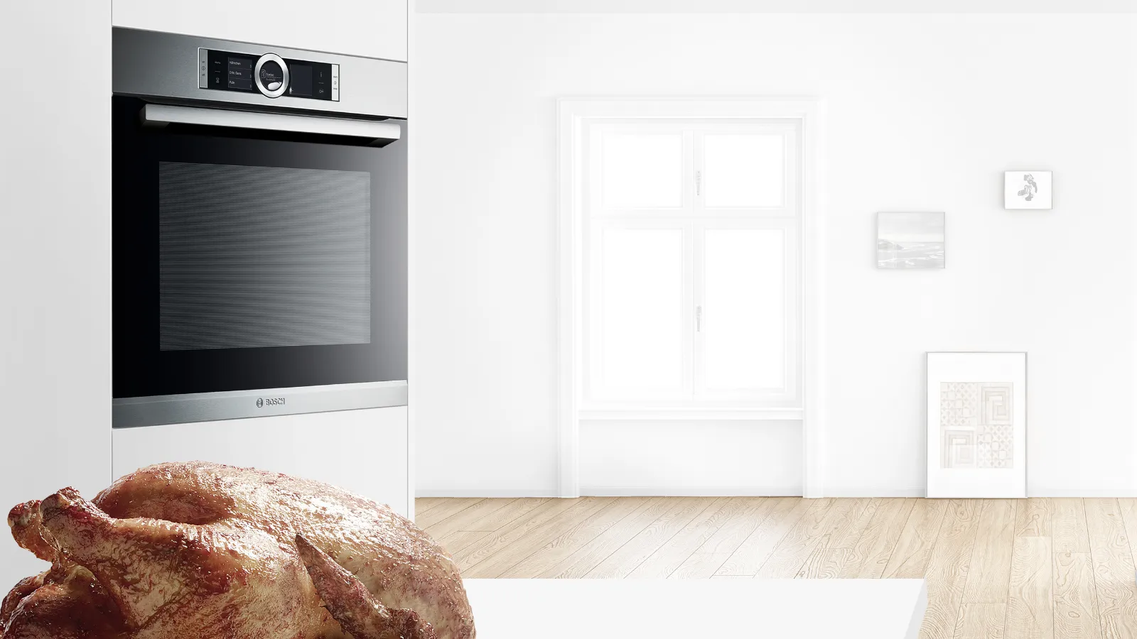 Modern kitchen with oven, wooden floor, and white walls.
